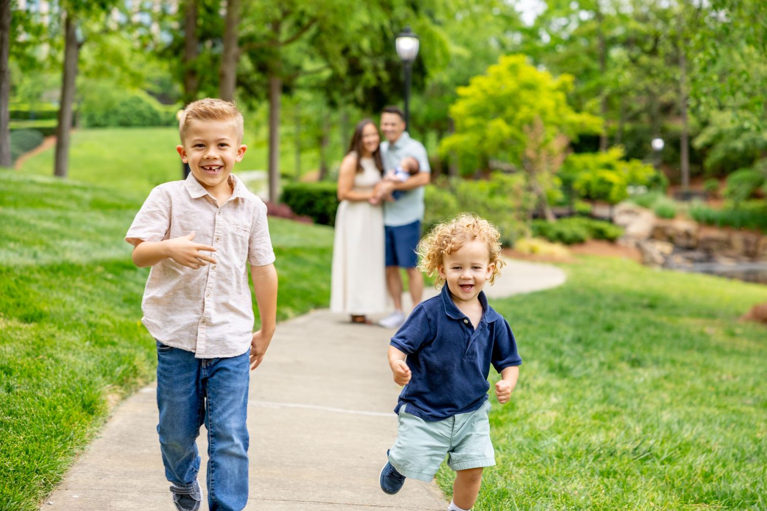 Dynamic scenes of family play and movement along a sunny park pathway.