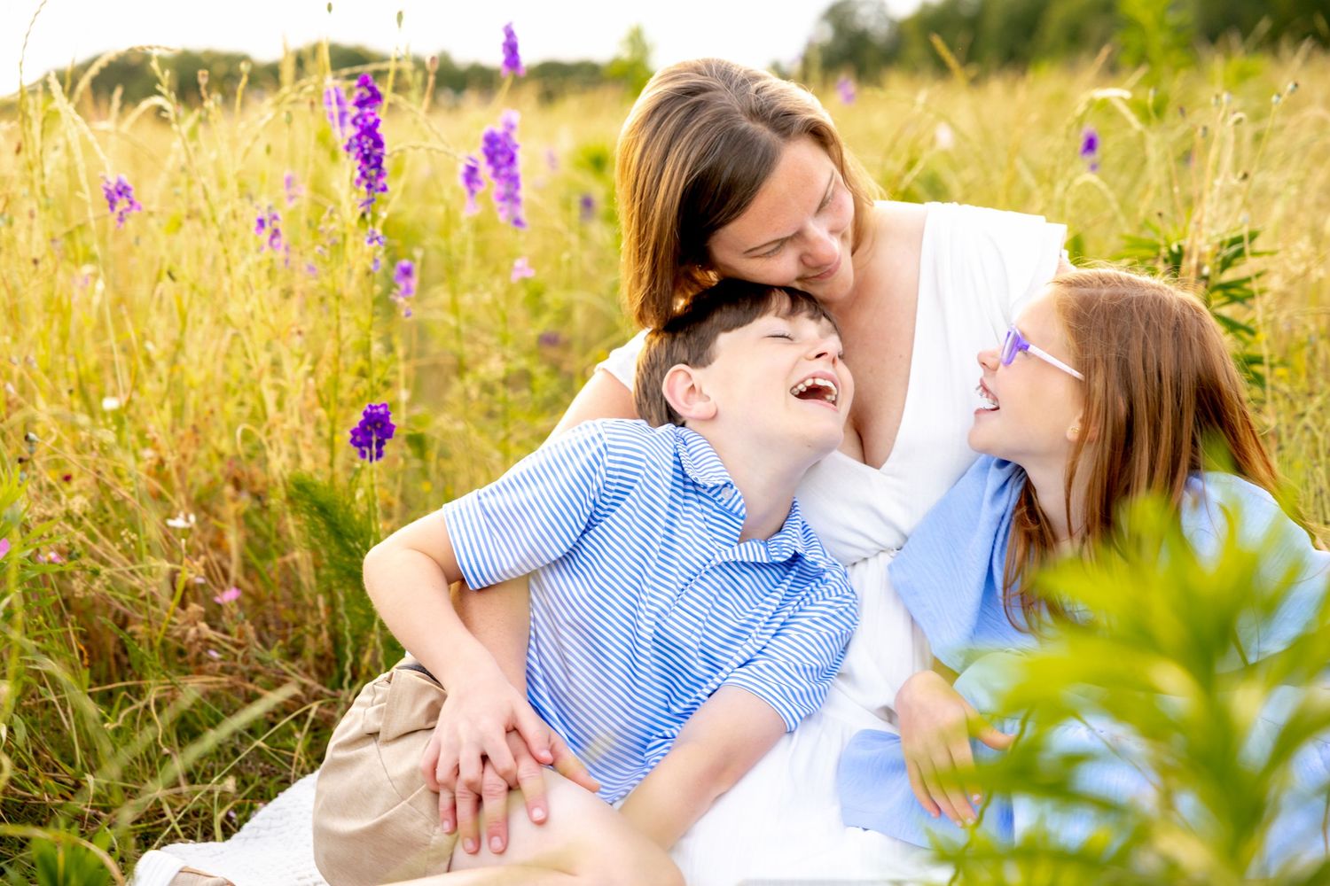 Candid moment captured in a sunny wildflower field with purple blooms at Blue Hill Garden in Monroe, NC.