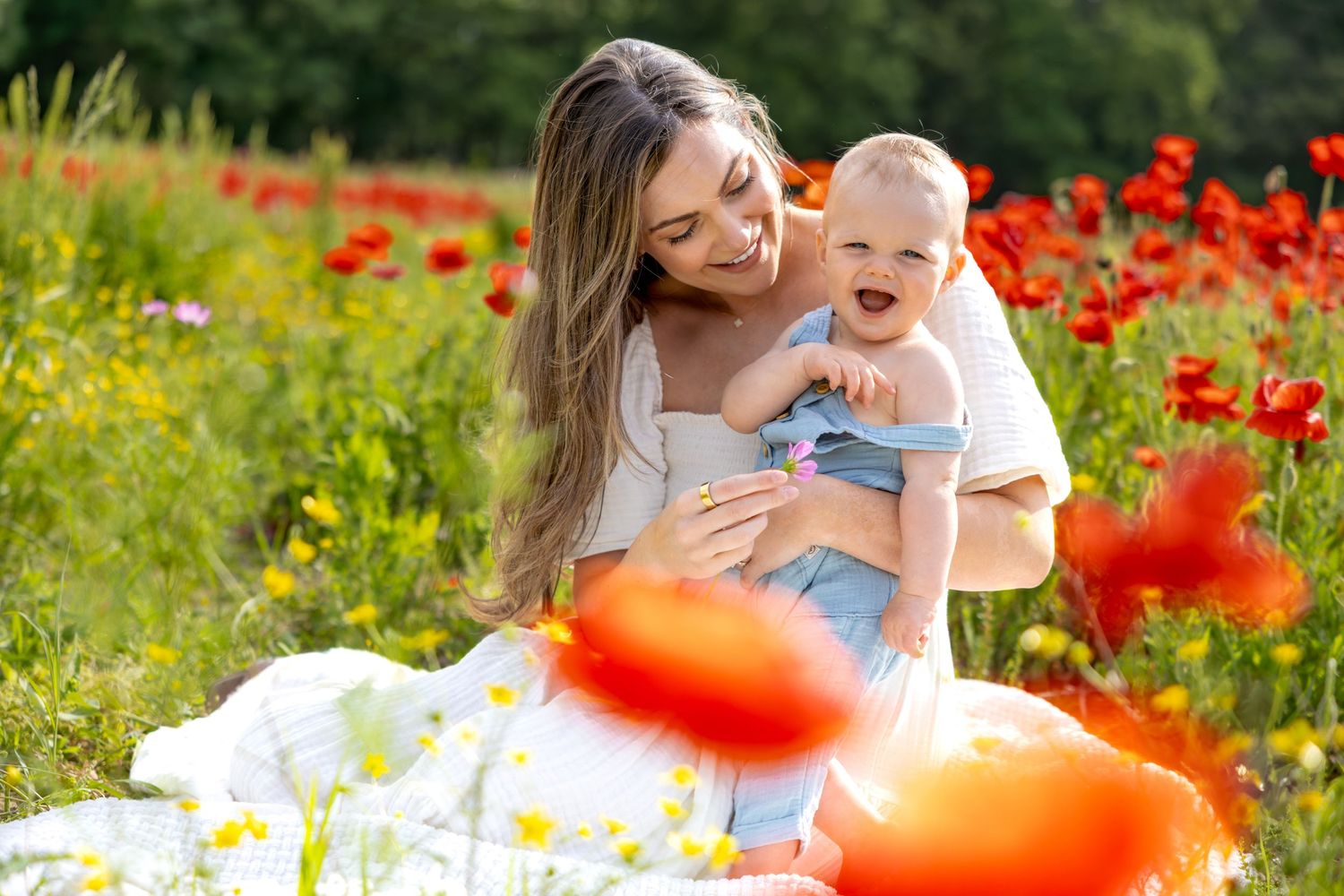 Natural outdoor family photography session in a field of red poppies and yellow flowers at Blue Hill Garden in Monroe, NC.