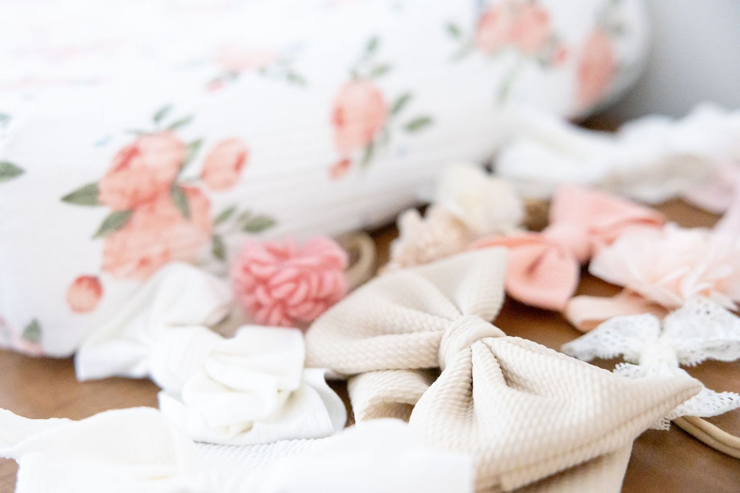 Delicate white flower petals and ribbons arranged on a light surface in a soft, romantic style.