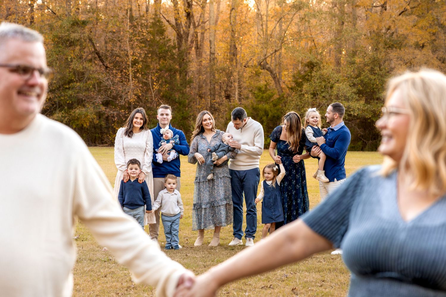 Extended family gathering photos captured in warm autumn sunlight.