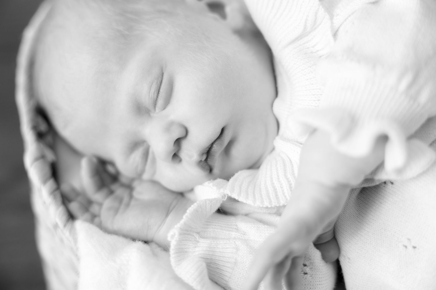 Peaceful black and white newborn portrait showing gentle expressions during a quiet moment.