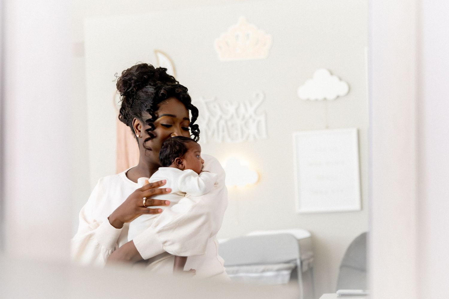 Bright lifestyle photo of family sharing affectionate moment in bedroom.