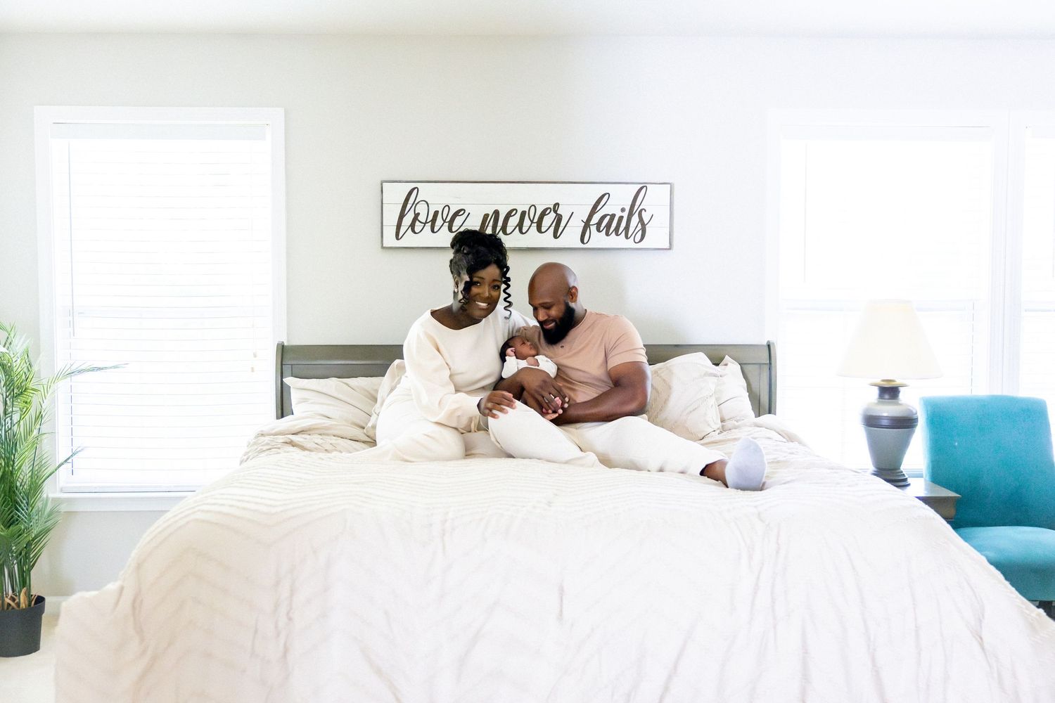 Bright and airy bedroom photoshoot shows loving family moments on white bedding.