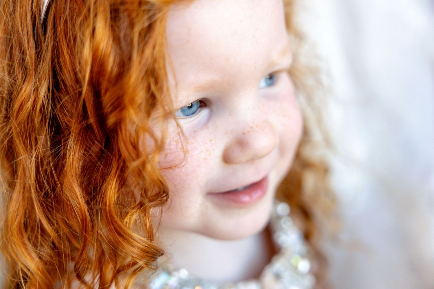 Artistic close-up portrait with soft natural lighting and dreamy bokeh effect.