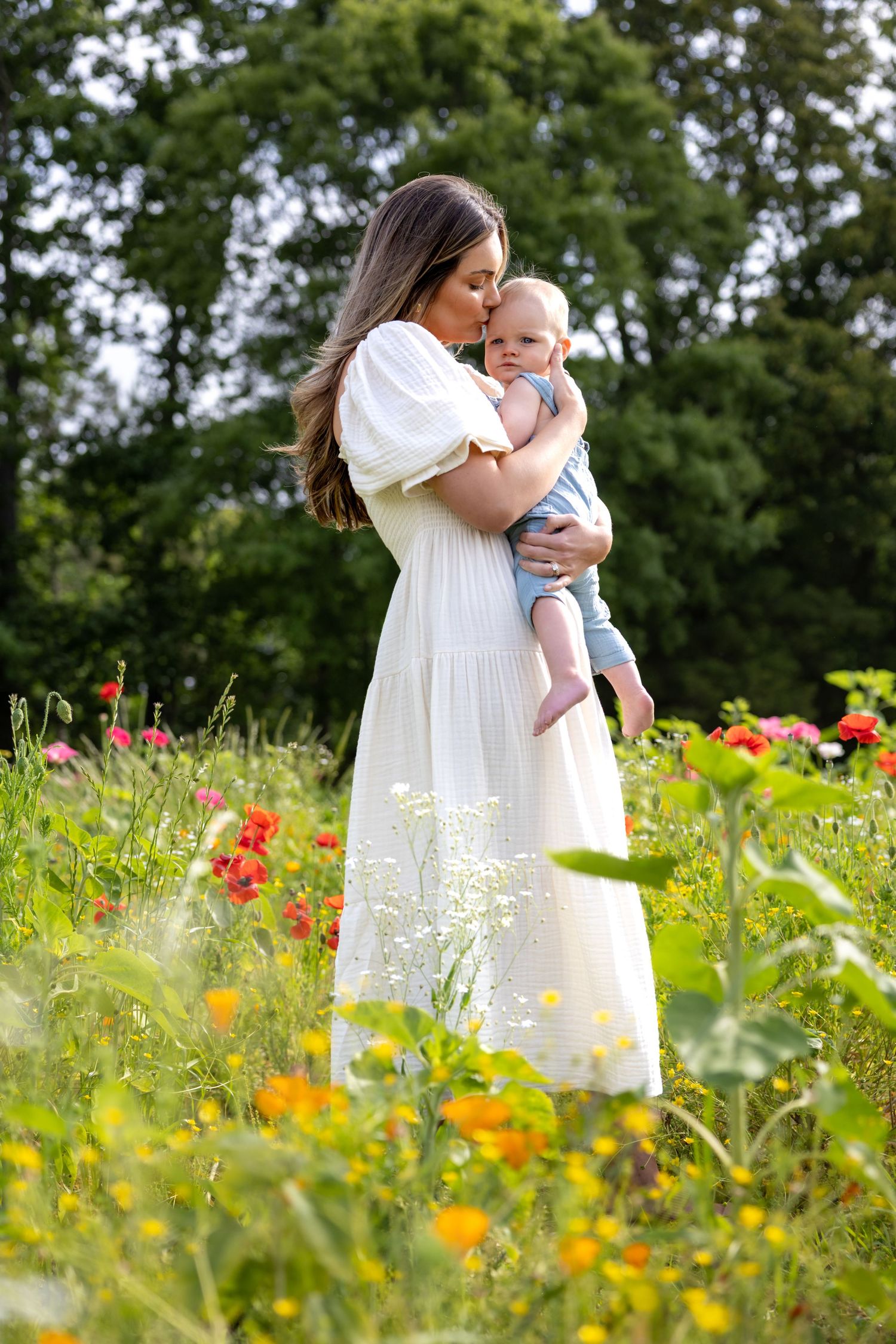 Elegant white dress stands out among colorful wildflowers in a summer meadow at Blue Hill Garden in Monroe, NC.
