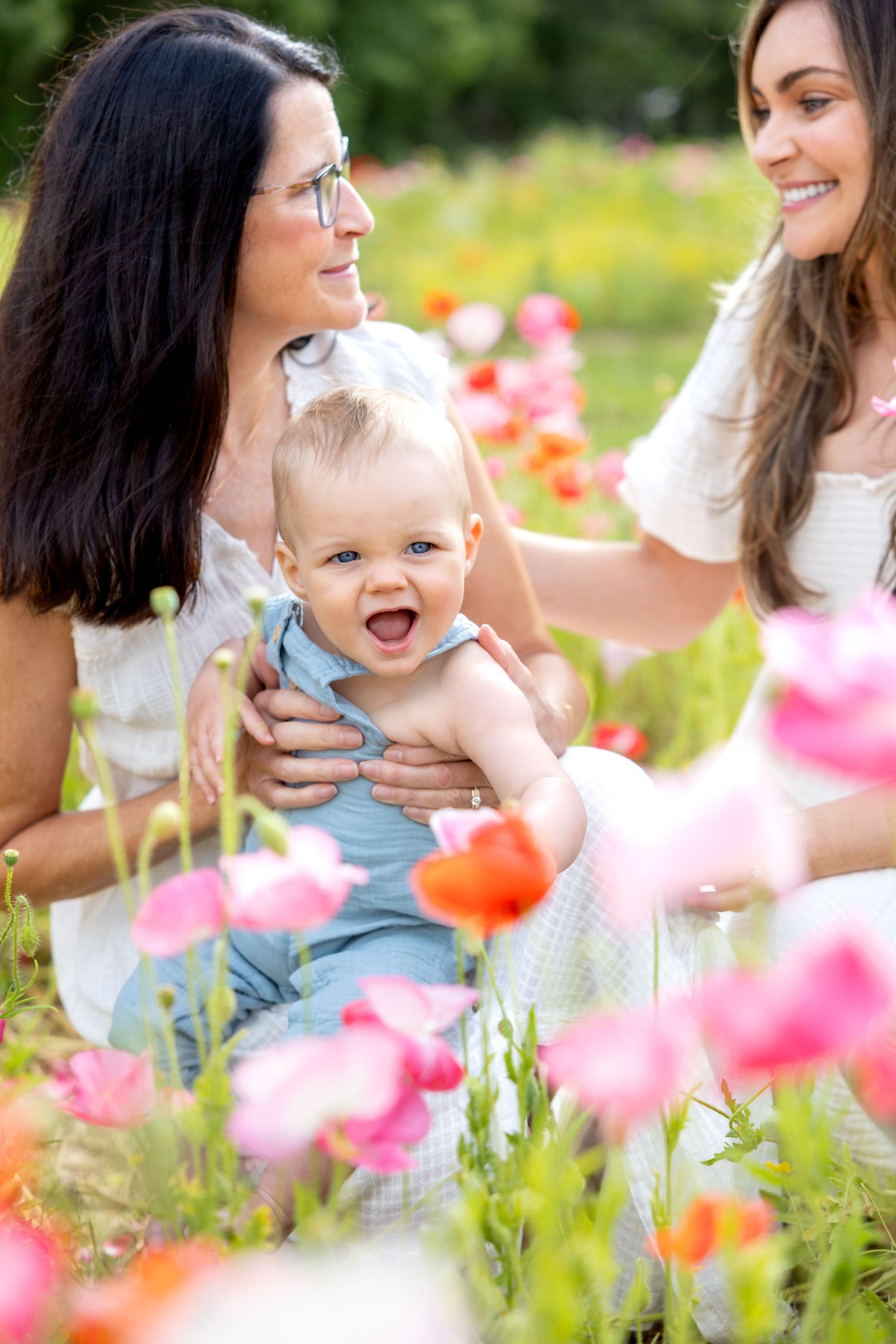 Candid shots of family joy amidst blooming poppies and wildflowers in a summer meadow at Blue Hill Garden in Monroe, NC.