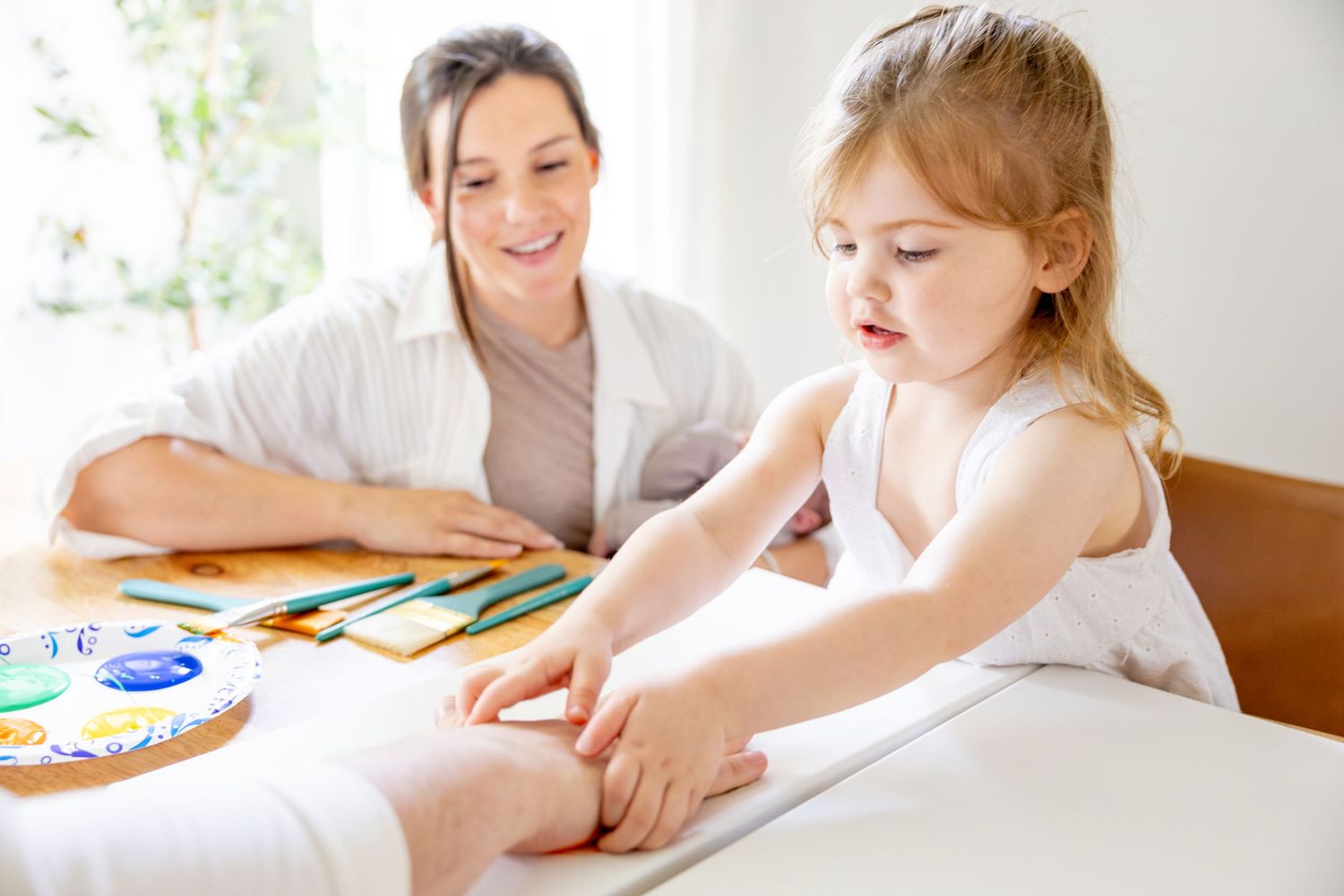 An engaging art activity session with colorful supplies on a white table.
