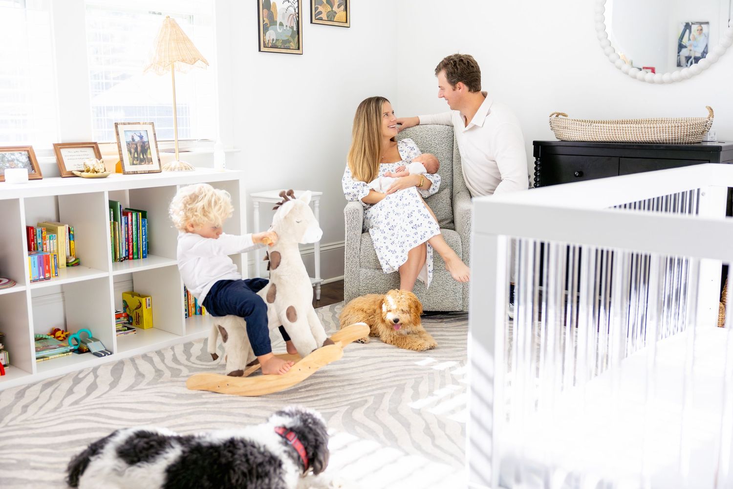 Modern nursery interior with white furniture and natural lighting.