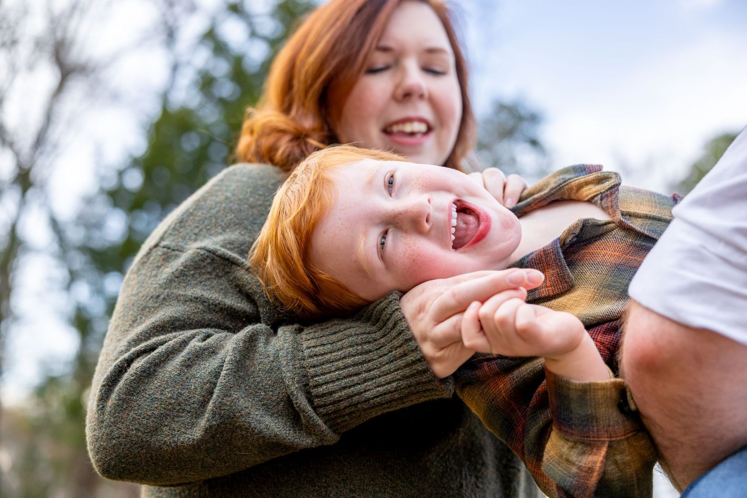 Joyful candid moments captured during outdoor family photoshoot.