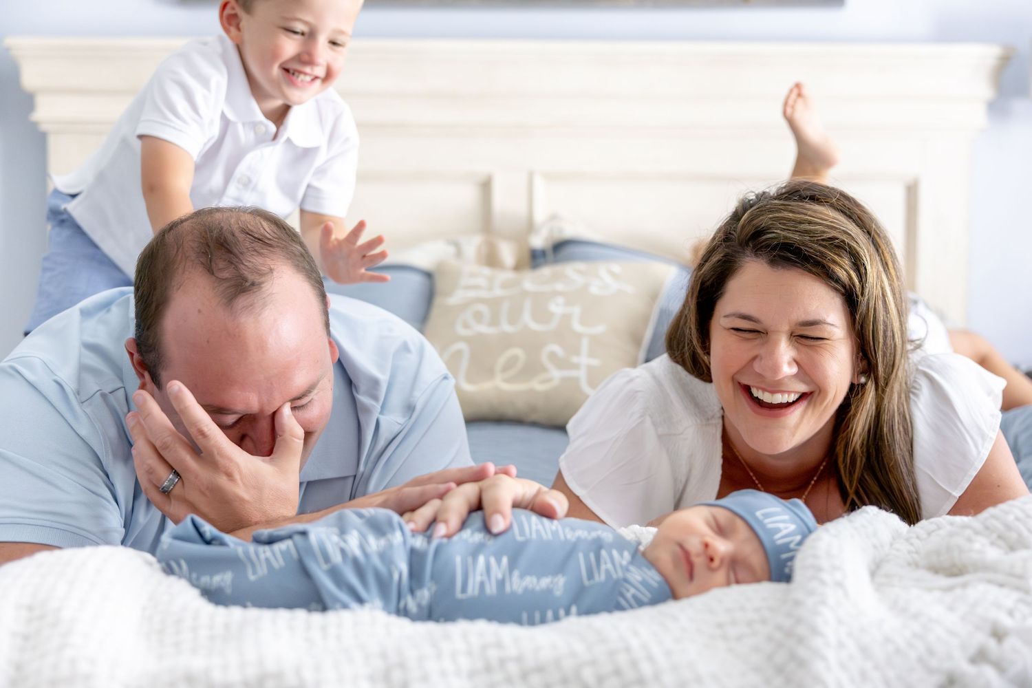 Happy family members enjoying quality time together on bedding.
