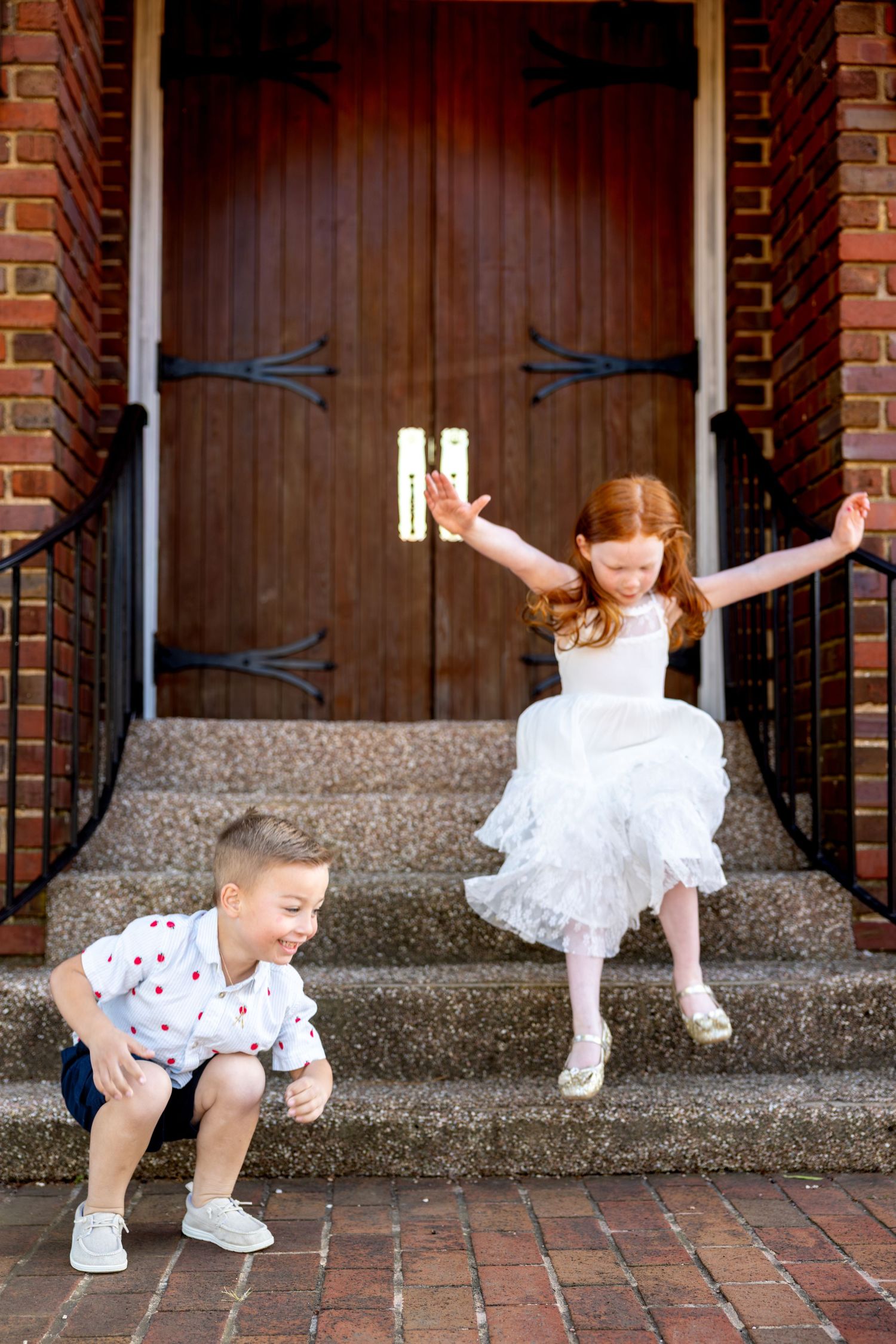 Series of playful dance poses by kids in front of wooden church doors and brick walls.