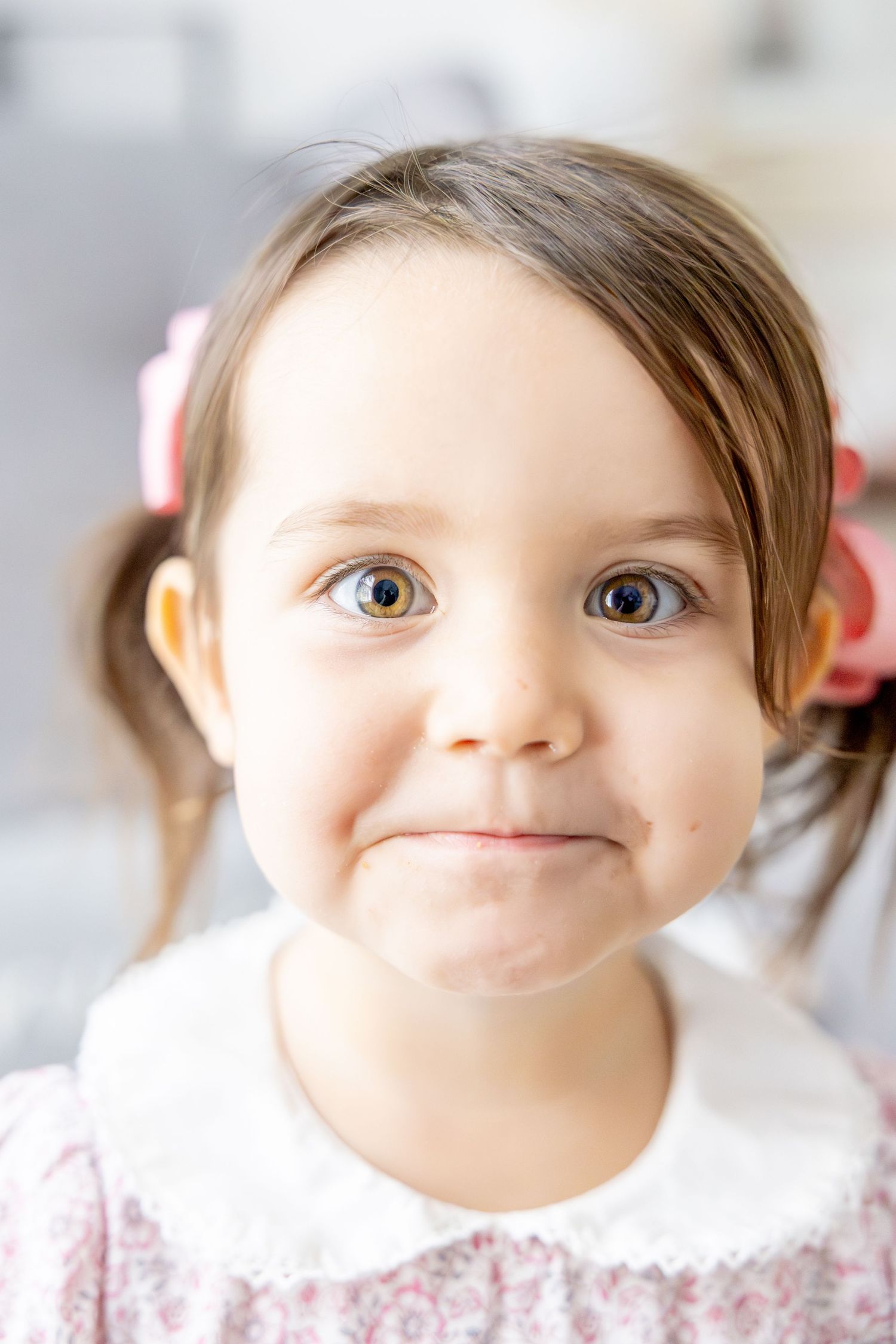 Close up portrait showing bright eyes and sweet smile in natural light.