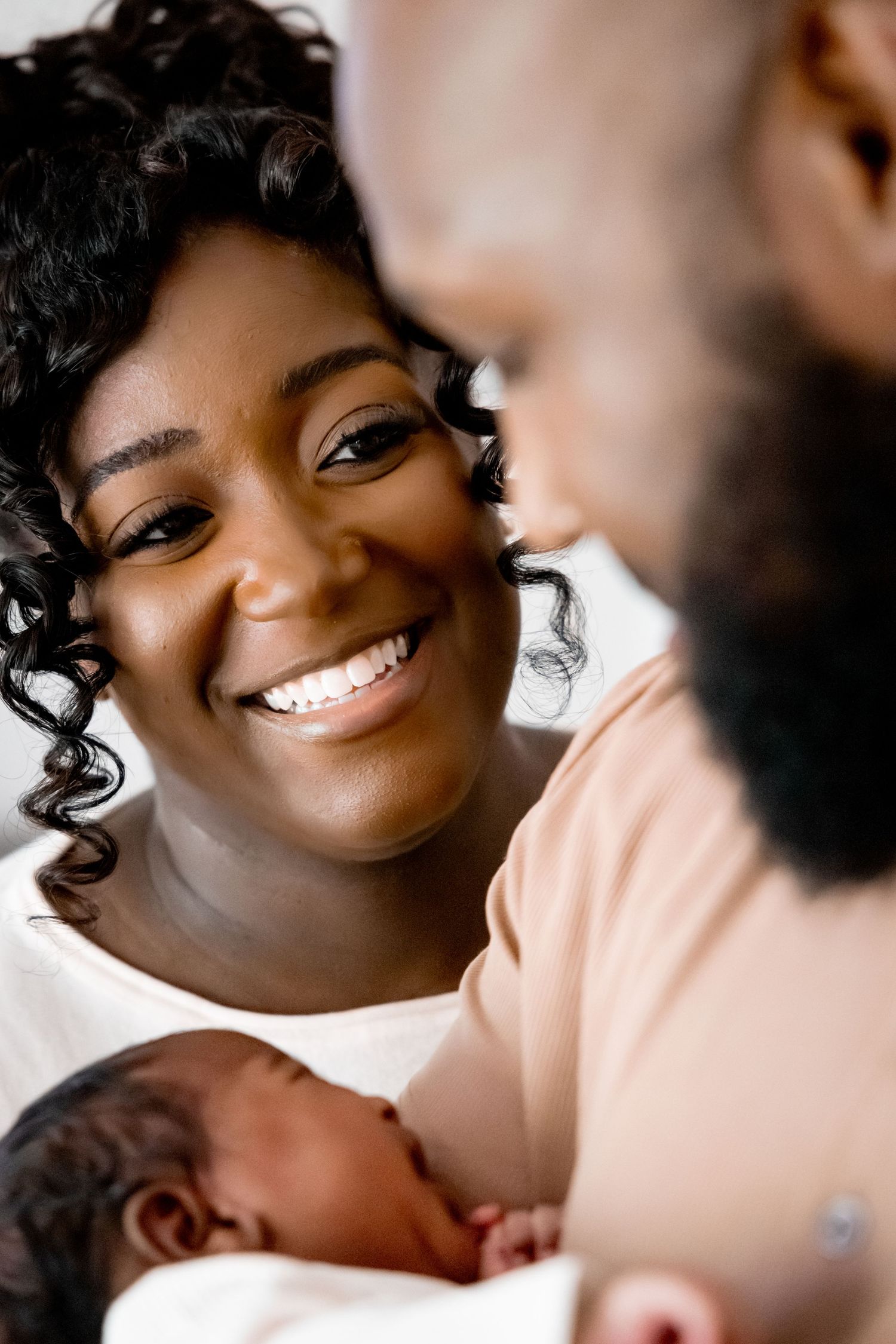 Joyful expressions and intimate smiles shared during a warm family photoshoot session.