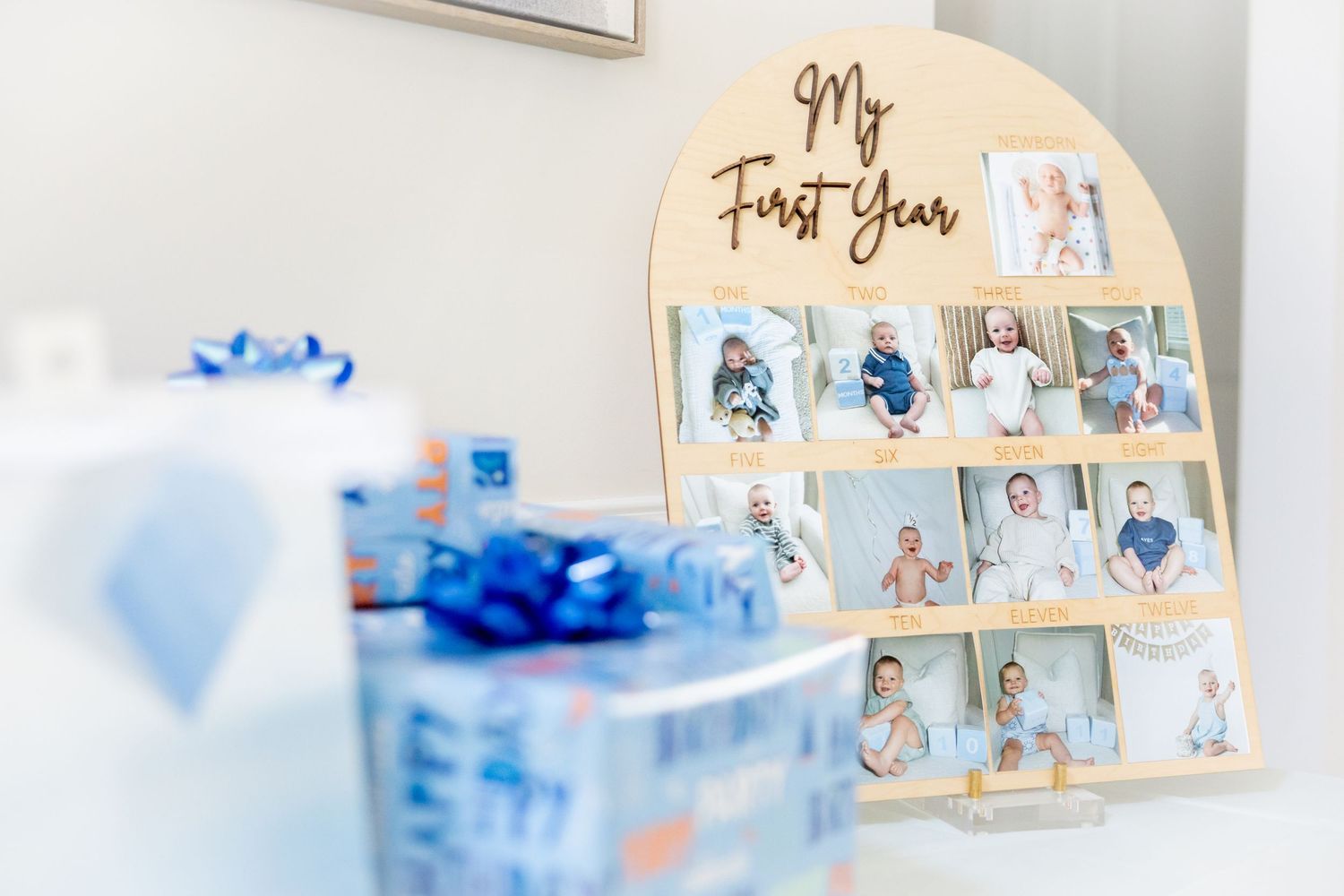 First year photo timeline display with baby pictures and decorative elements.