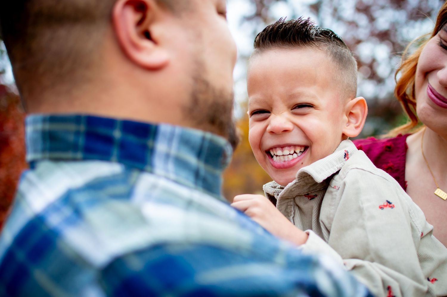Joyful autumn family moment captured against colorful fall foliage in Lake Wylie, SC.