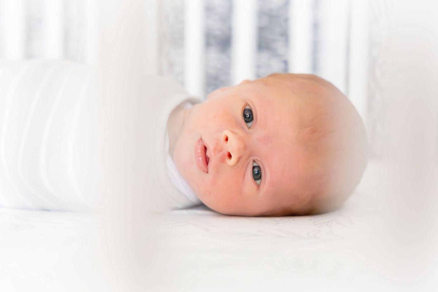 Close up portrait of an infant on a white background.