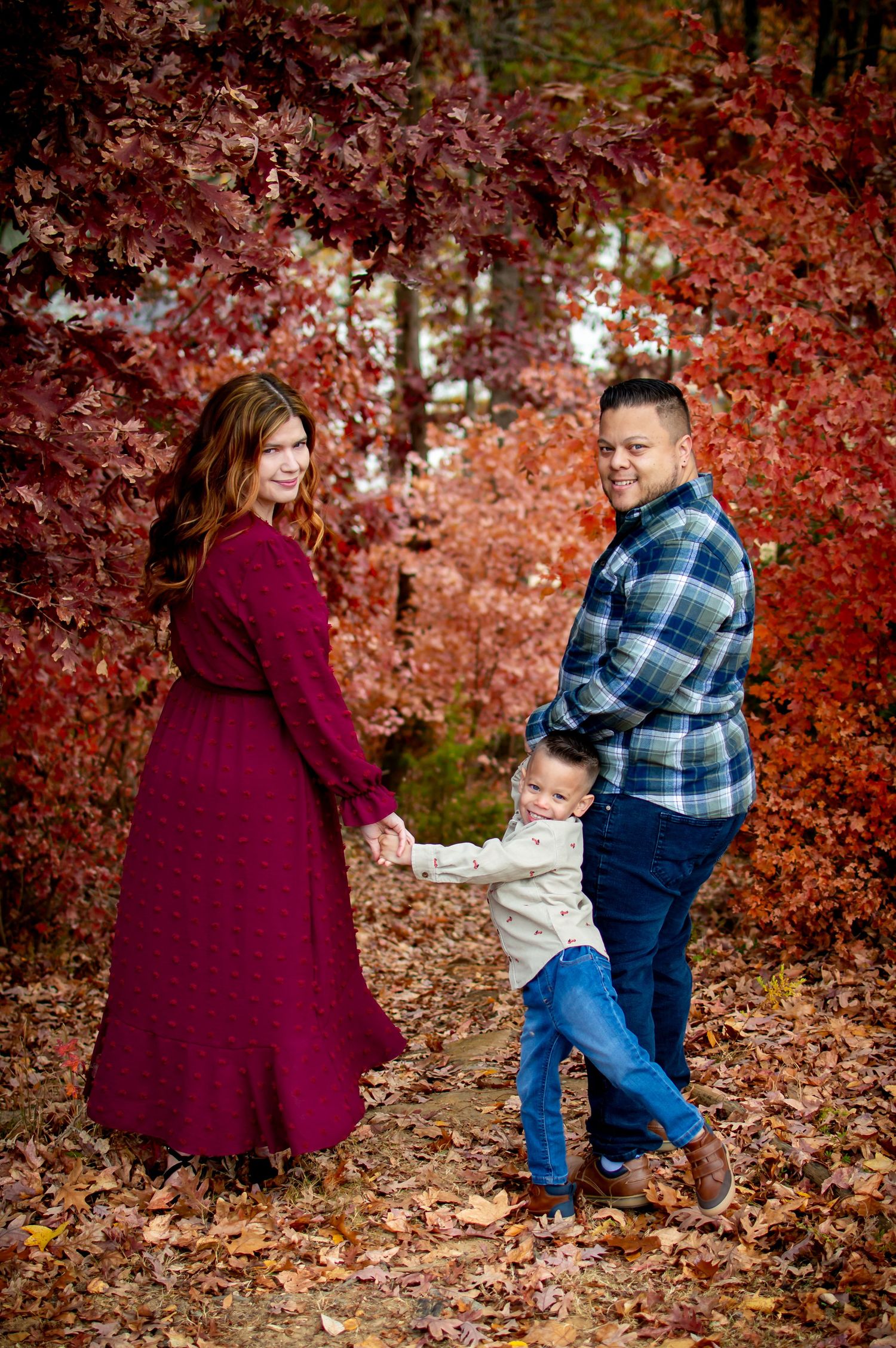 Playful family moments captured in sequence against red autumn leaves in Lake Wylie, SC.