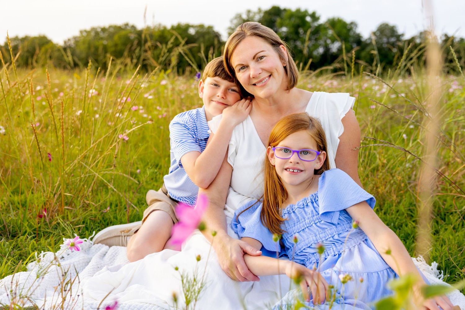 A candid moment of relaxation together on a blanket in a golden summer meadow at Blue Hill Garden in Monroe, NC.