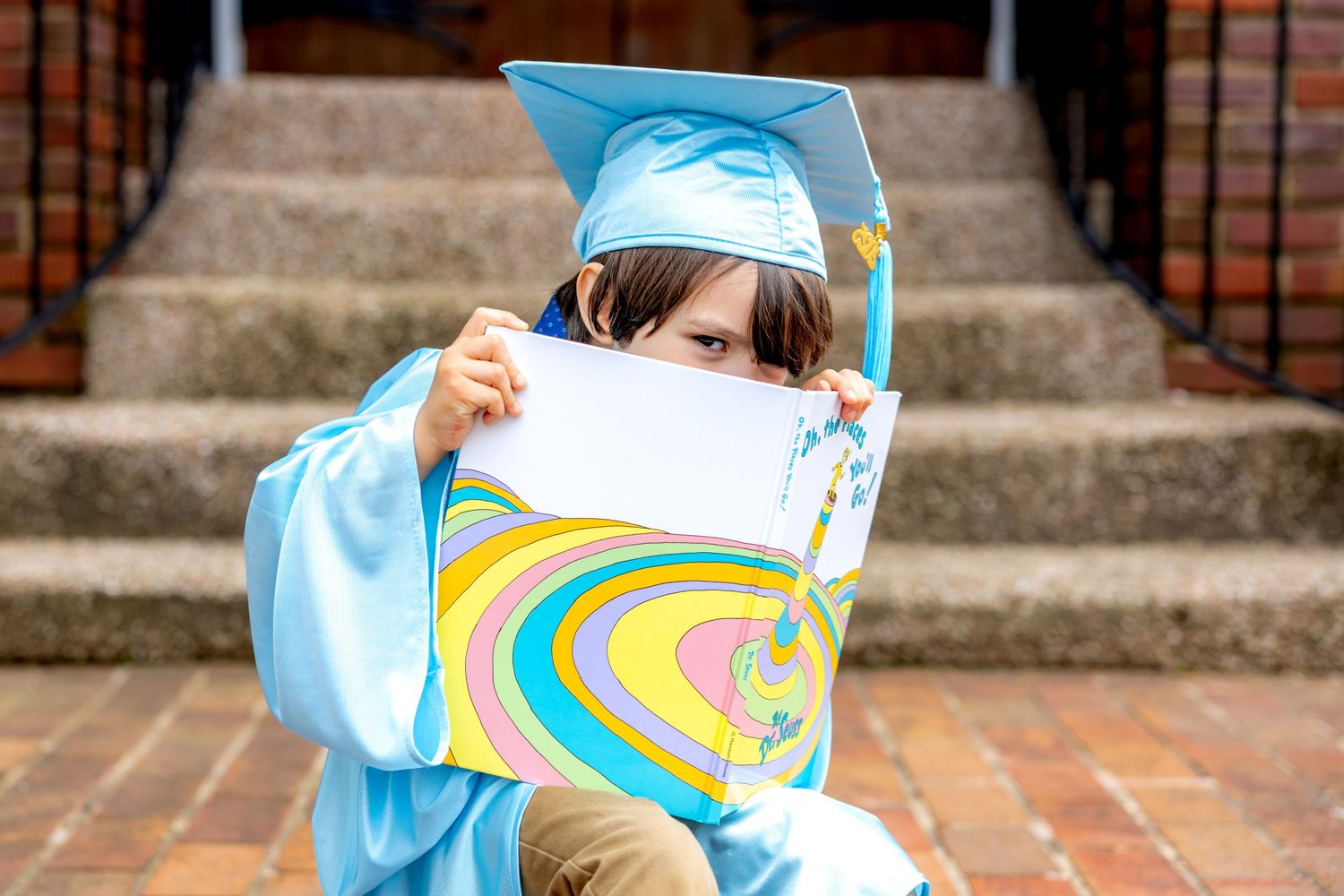 Scenes of playful movement while wearing light blue preschool graduation caps.