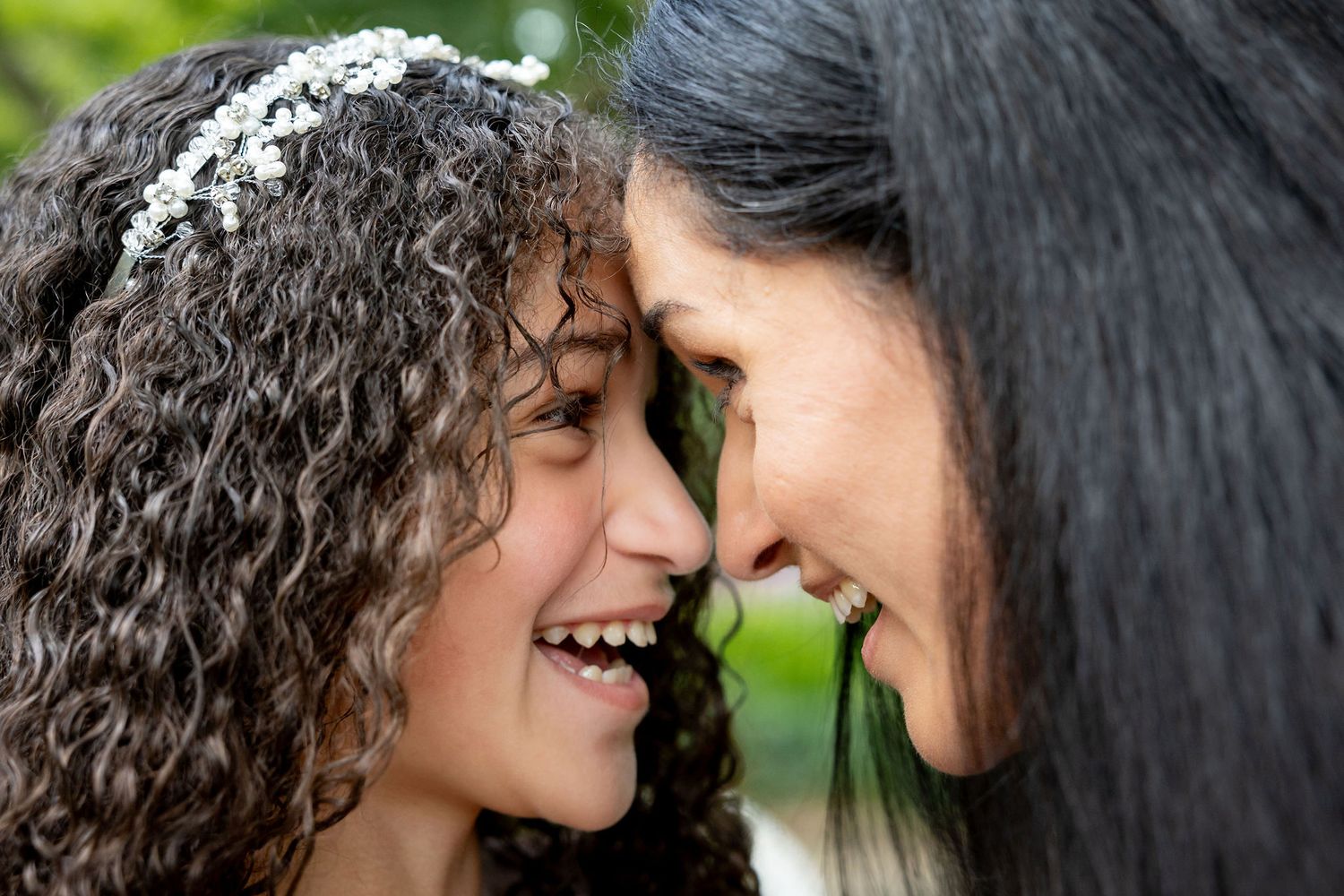 Close-up photos showing intimate moments between a couple with natural outdoor lighting.