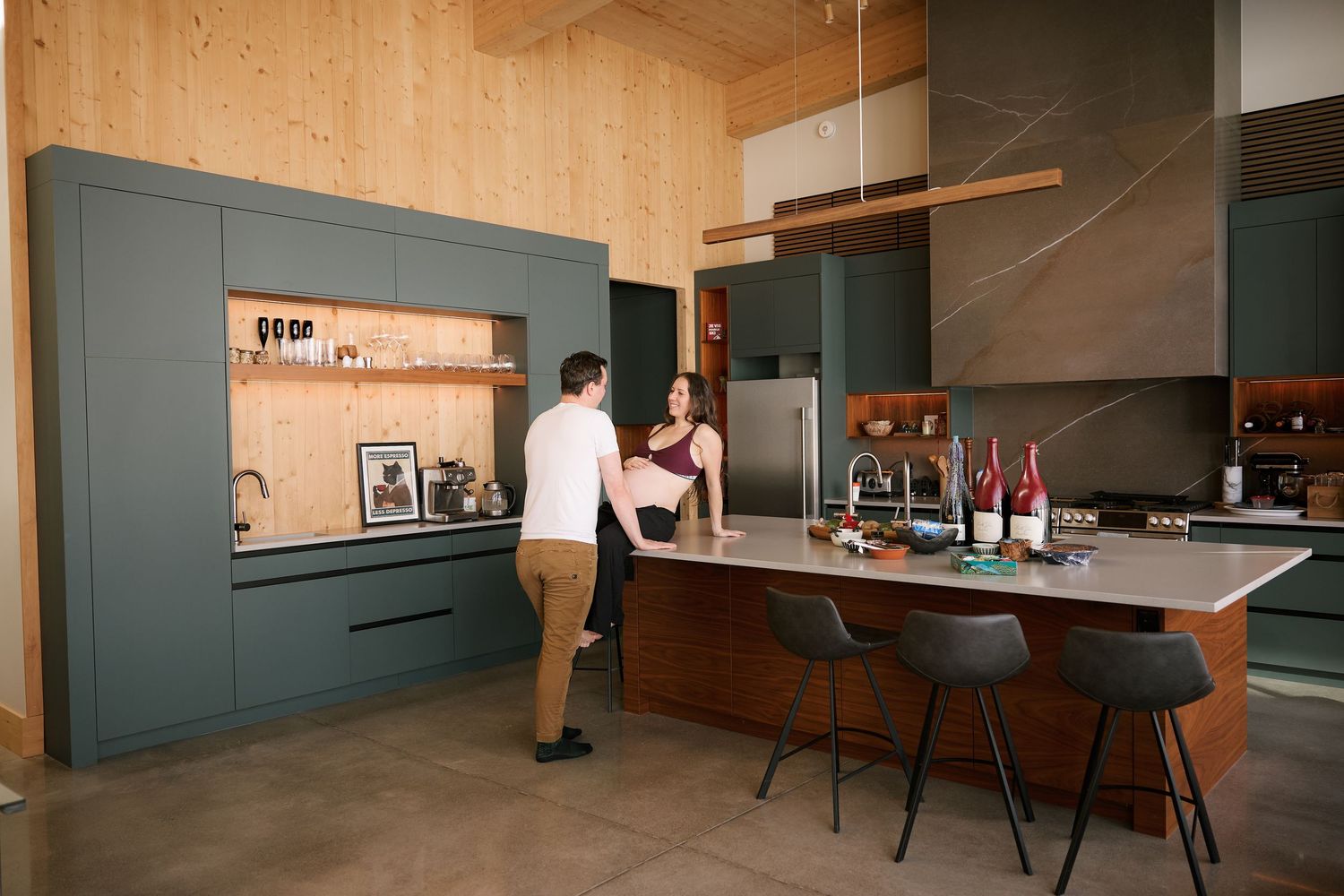 Modern kitchen interior with wood paneling and dark cabinets showcasing contemporary design and clean lines.