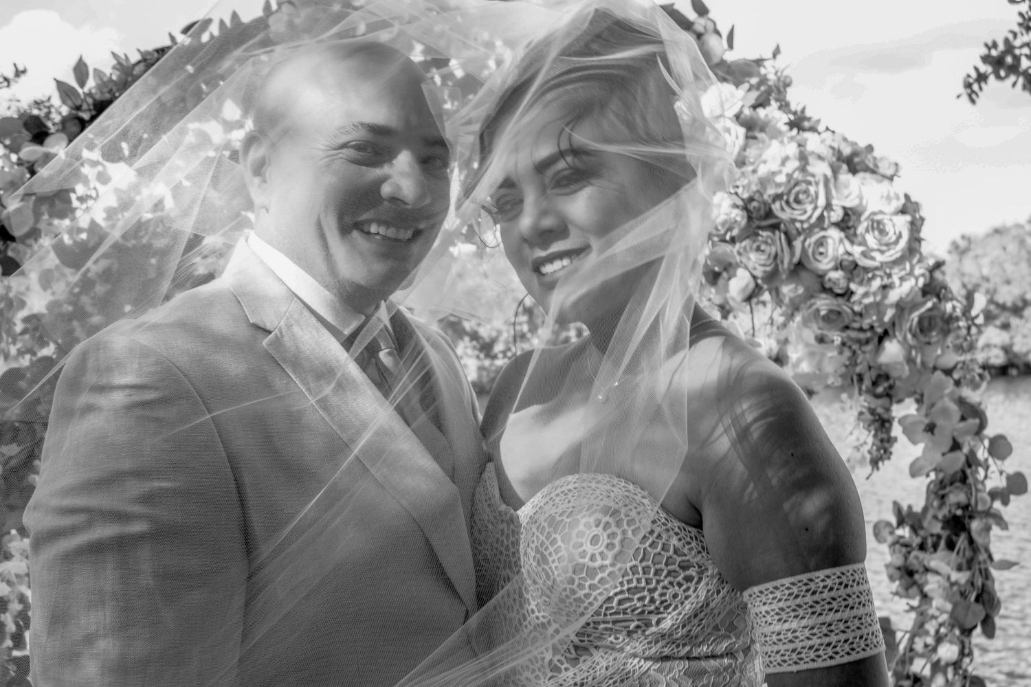 Romantic black and white wedding portraits through a delicate veil.