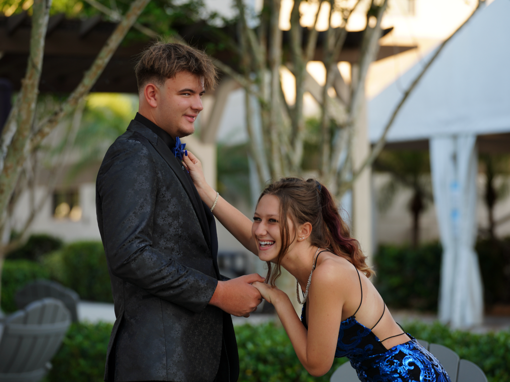 Couple sharing romantic moment in lush tropical garden setting.