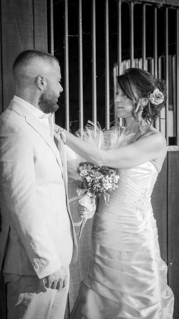 Candid black and white wedding photos showing playful moments between newlyweds.