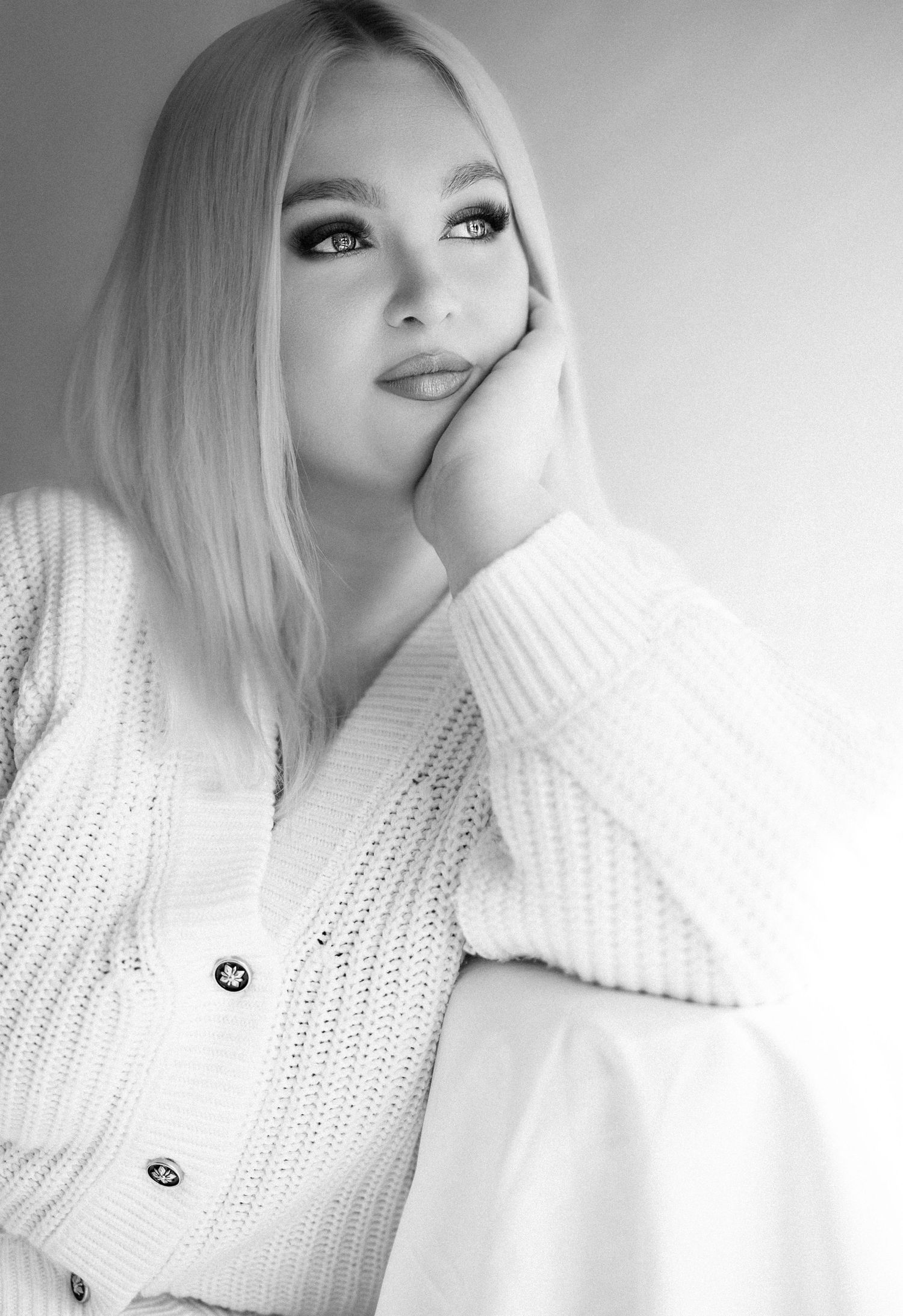 Minimalist portraits in white sweater showing different angles.