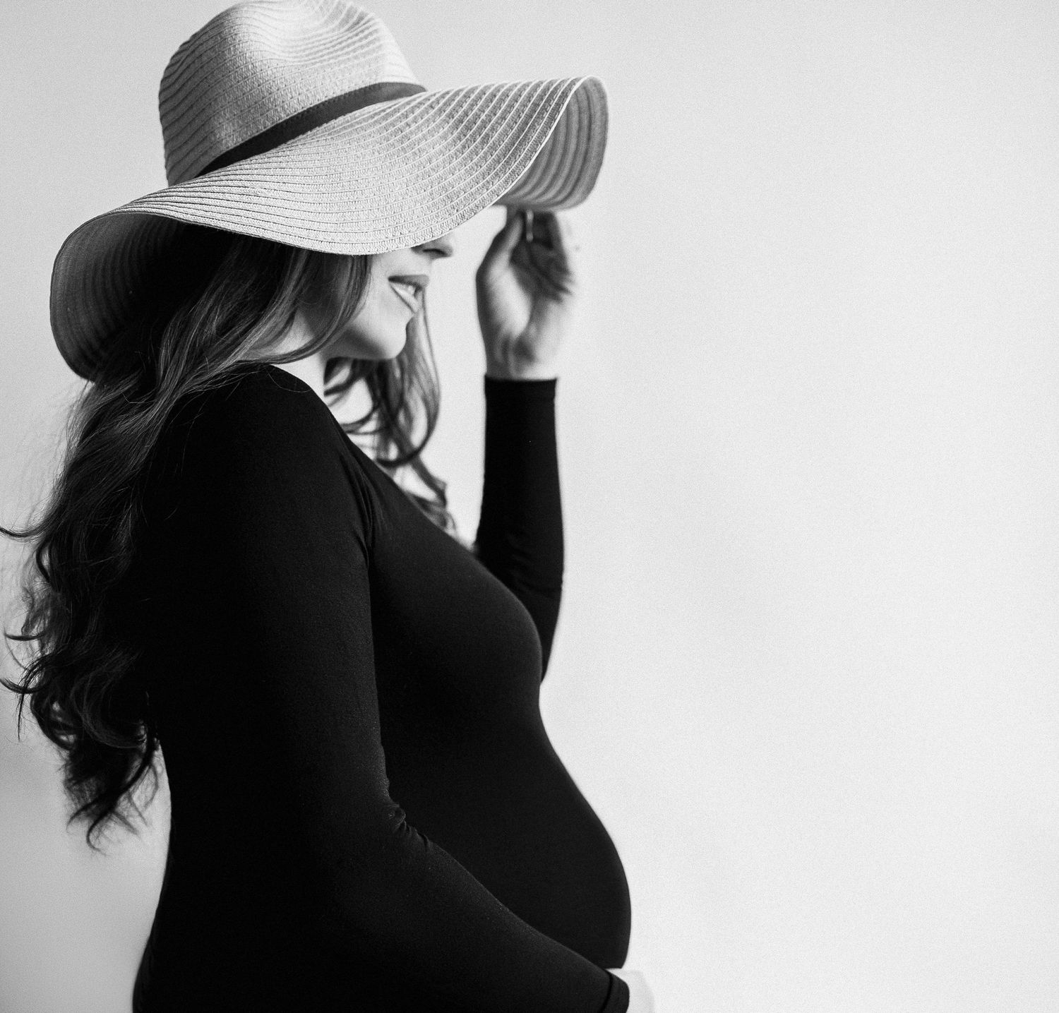 Black and white artistic portrait series showing dramatic poses against a light background.