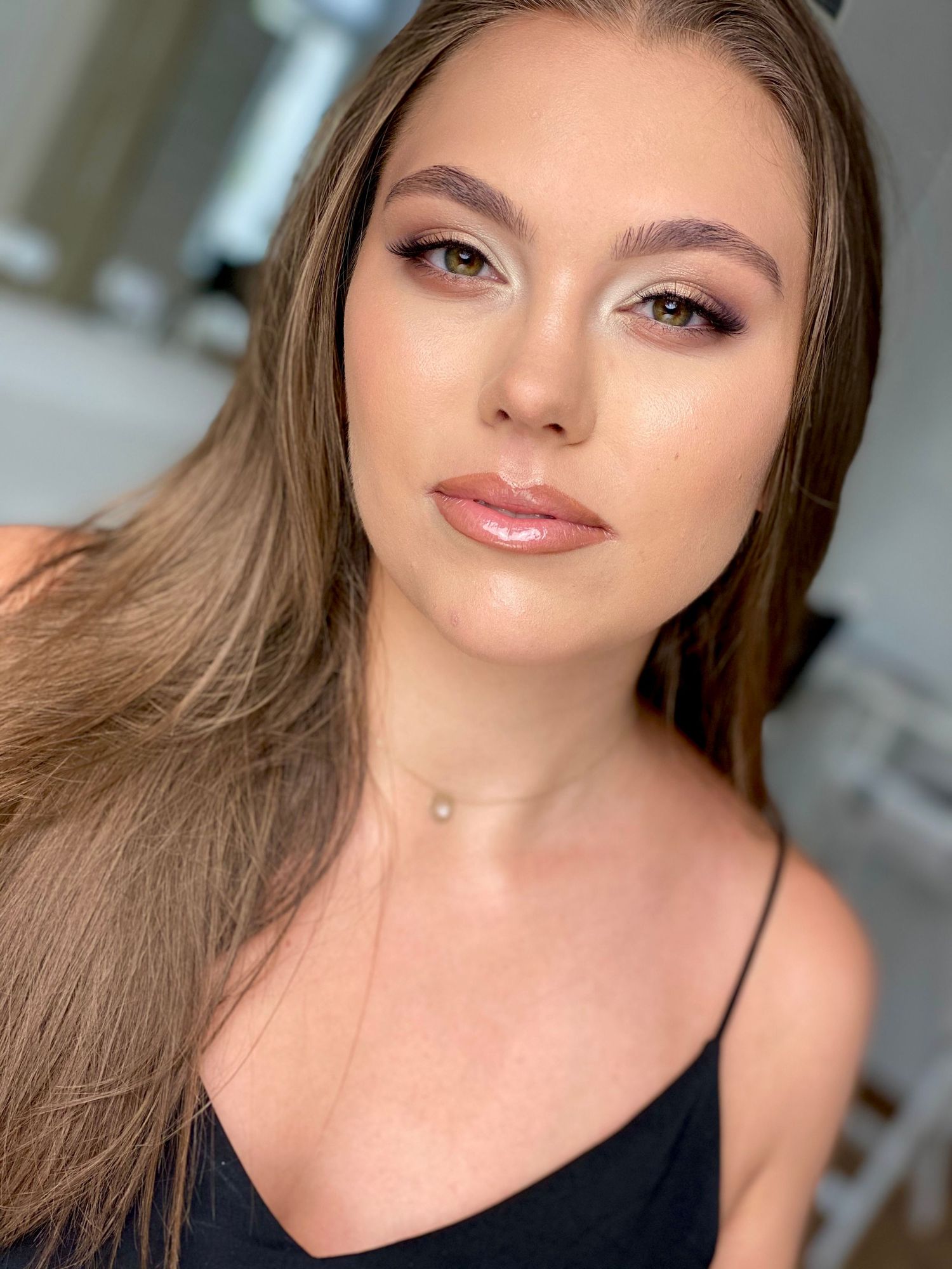 Close-up beauty shots with neutral makeup and long brown hair against light background.