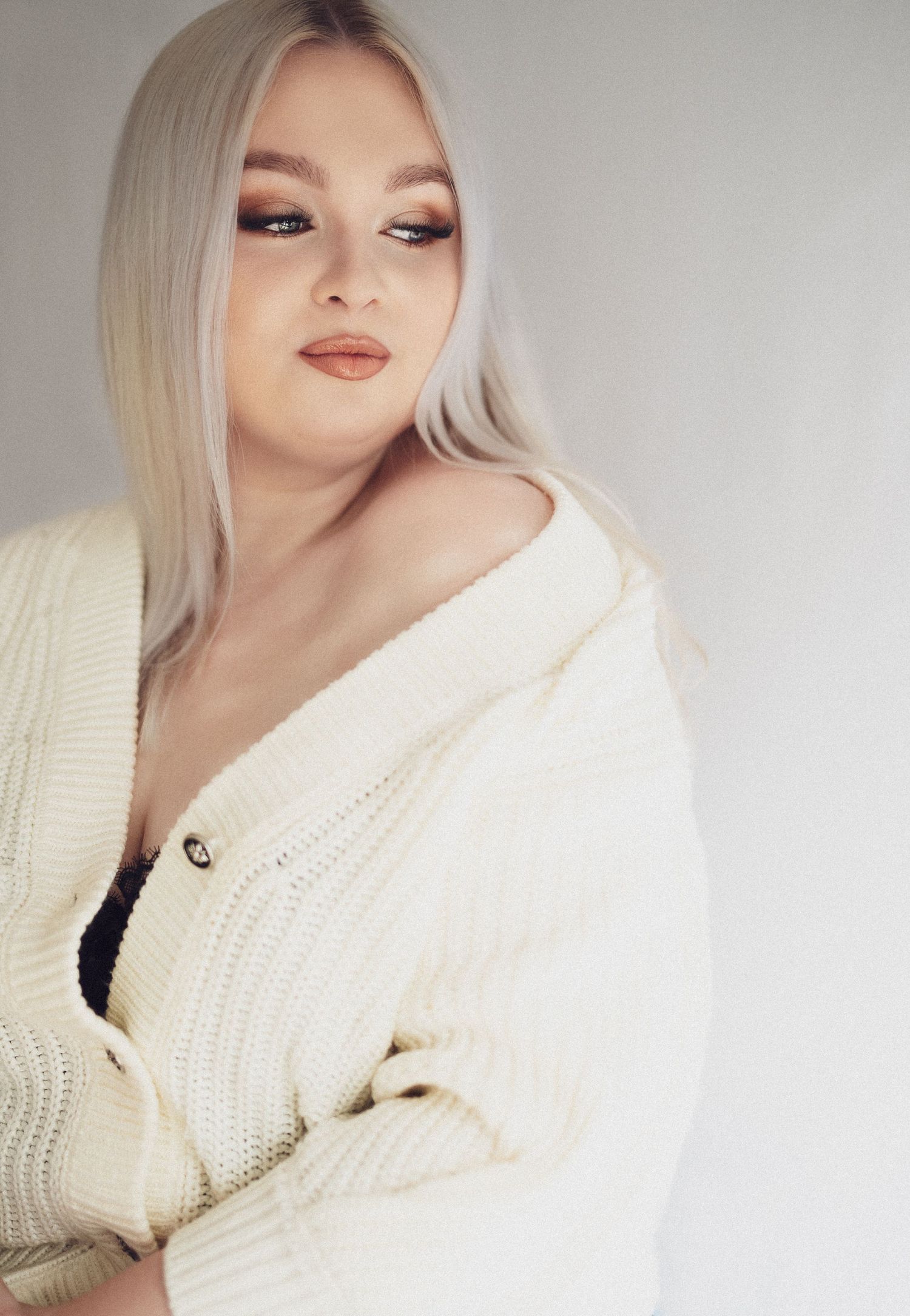 Fashion portraits in cream sweater showing sophisticated styling.