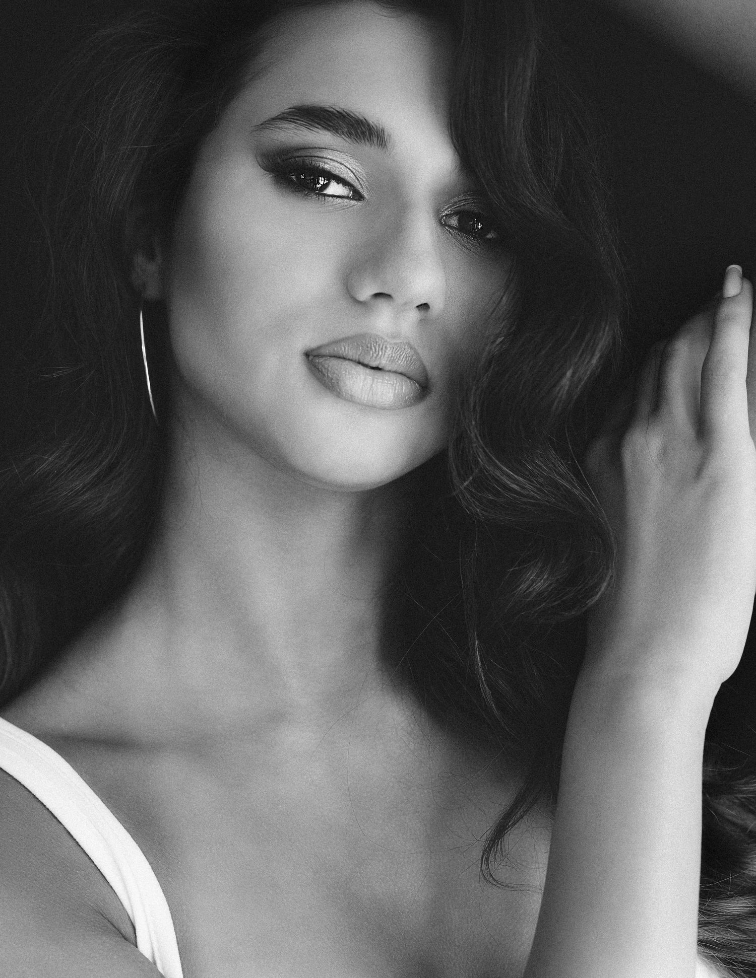 Dramatic black and white portrait series showcasing elegant makeup and soft lighting effects.