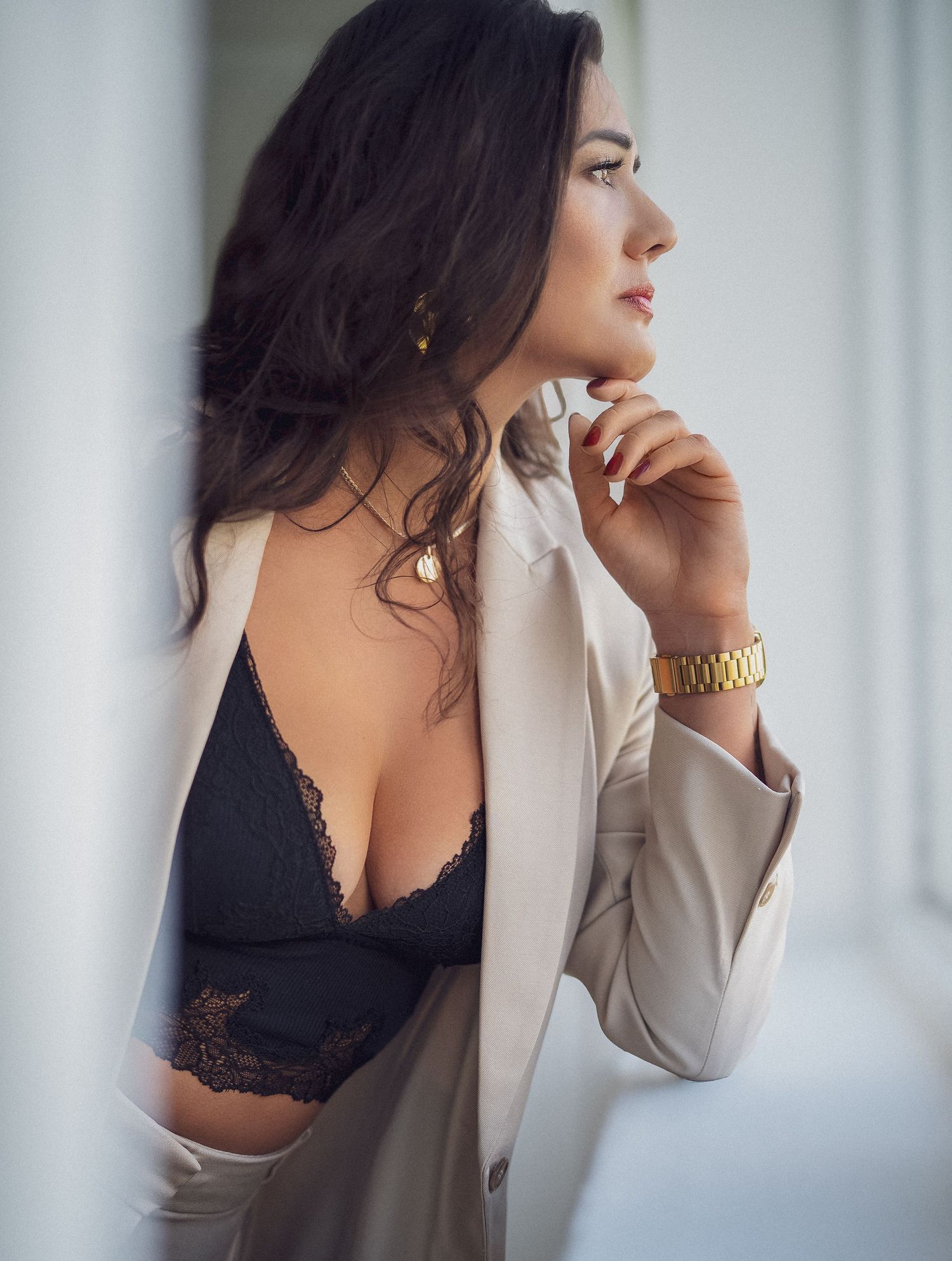 Artistic boudoir photo series showing a woman in black lace and white blazer against soft window light.