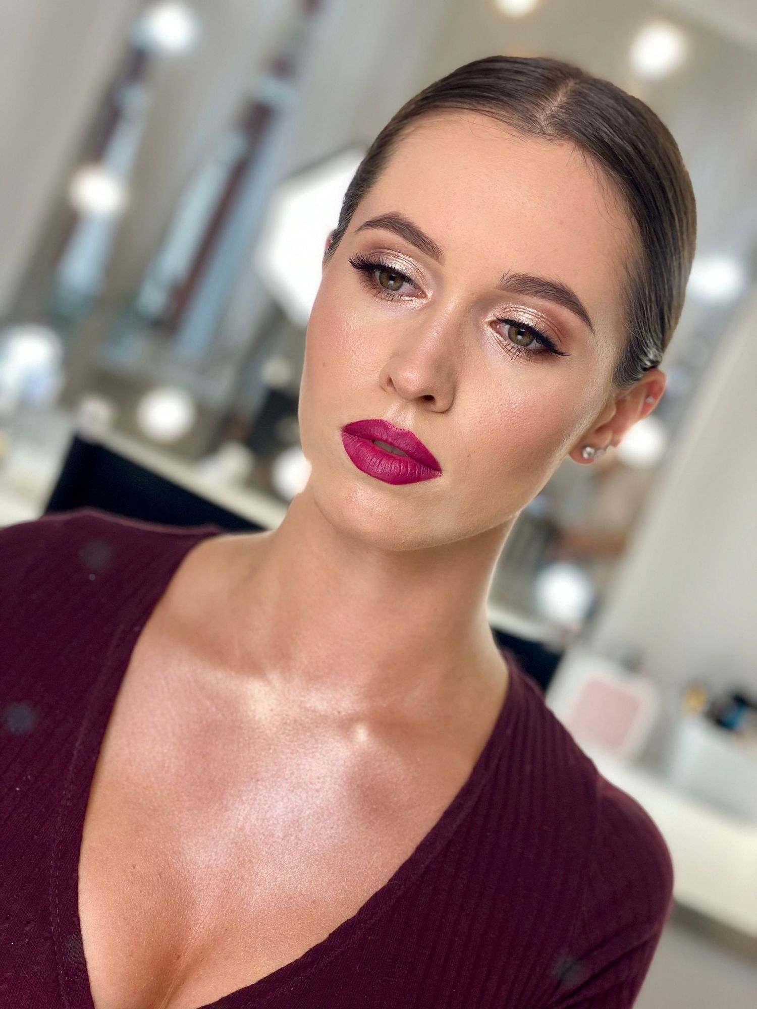 Beauty portrait series with burgundy lipstick and glowing skin in dark sweater.