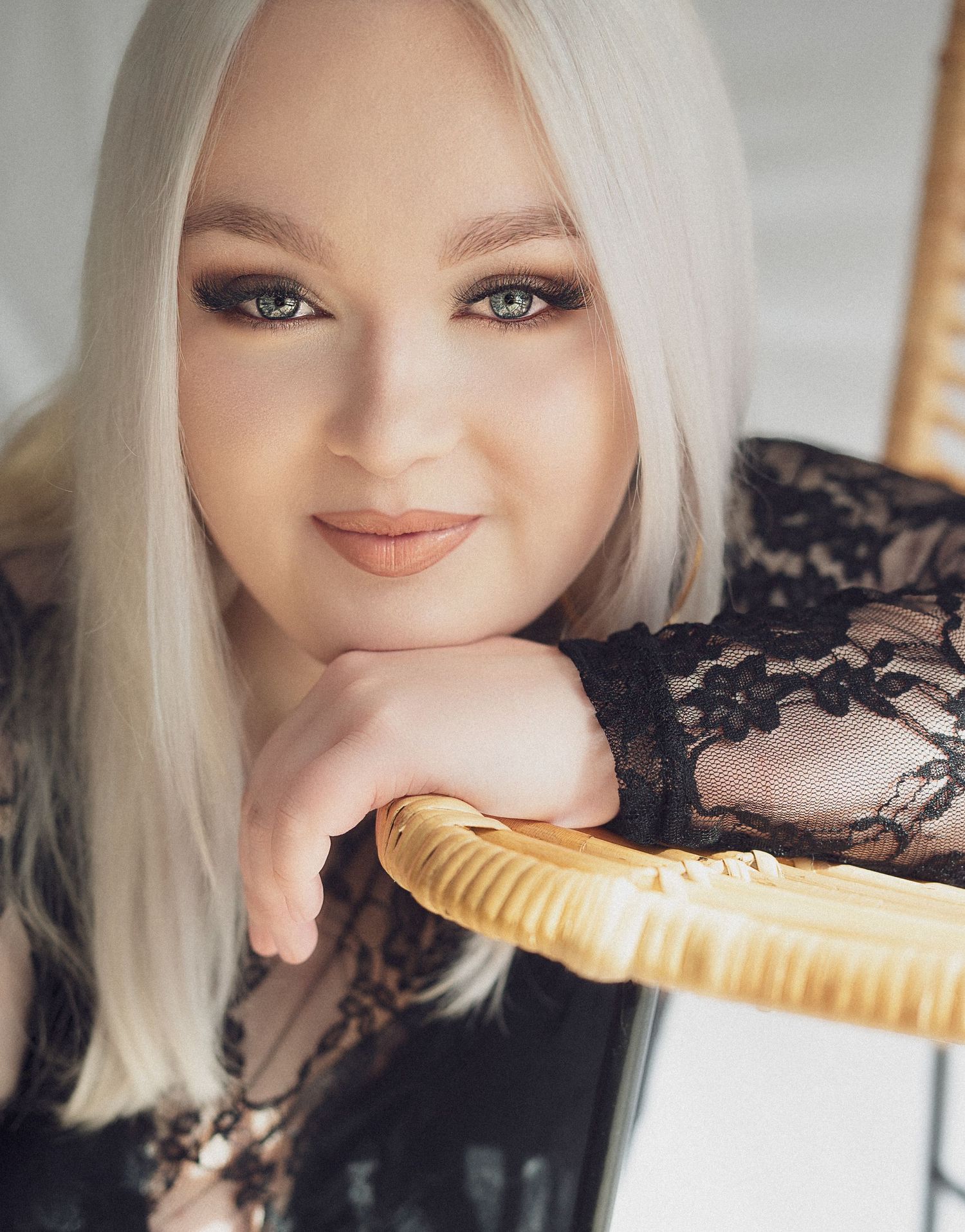 Expressive portrait series with brush prop and black lace details.