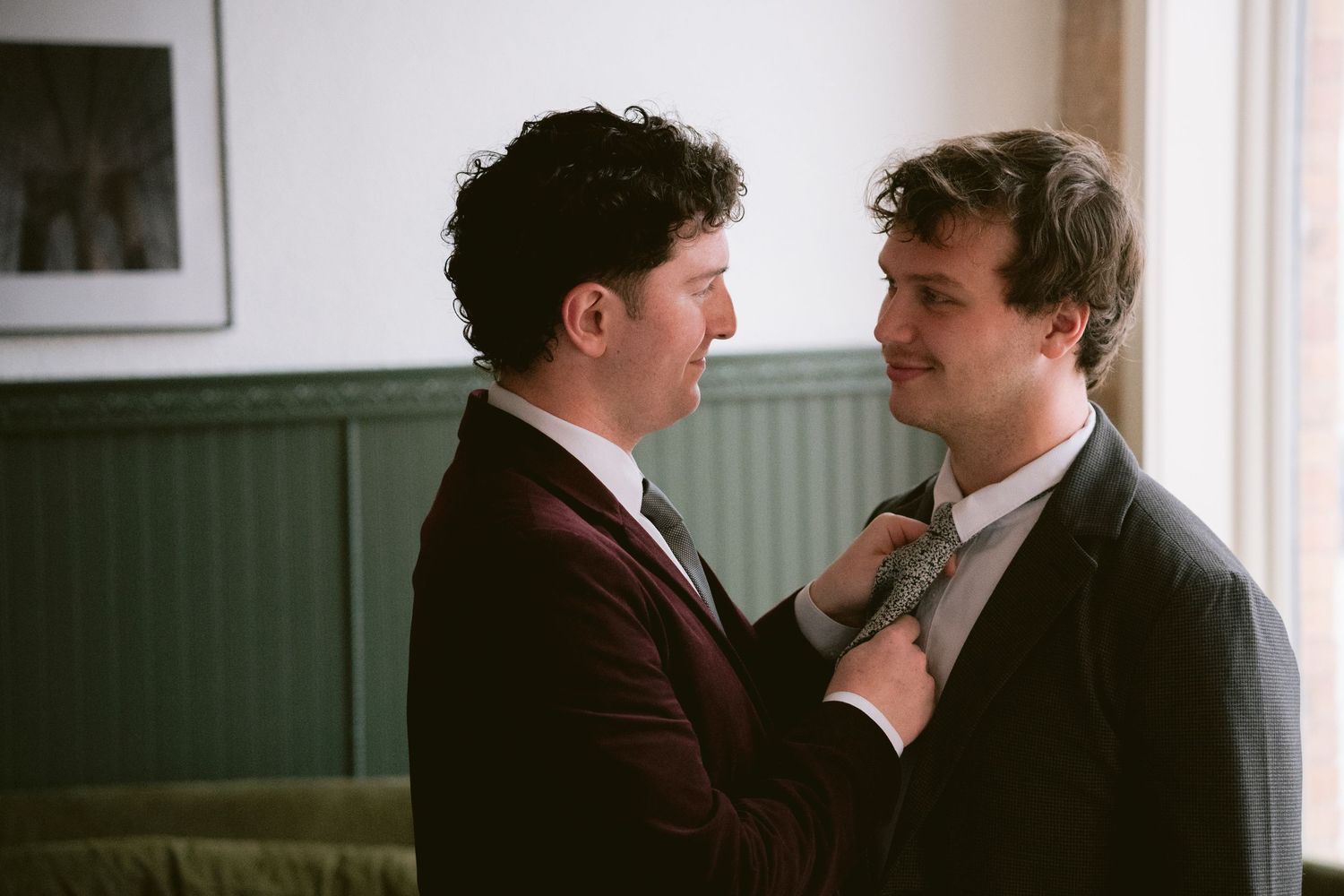A groom fixing his husband's tie