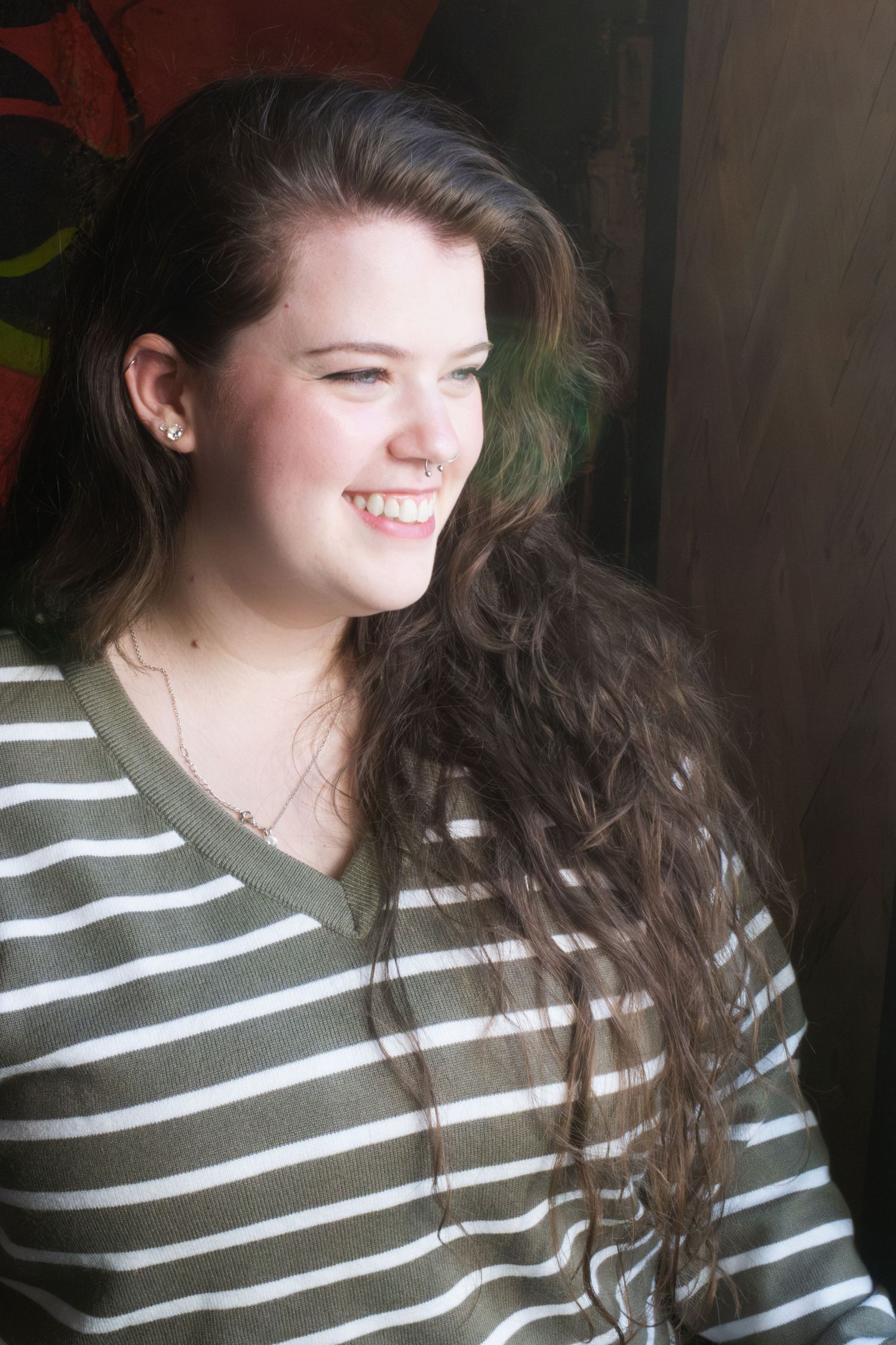 A woman smiling at a coffee shop in Denton, TX