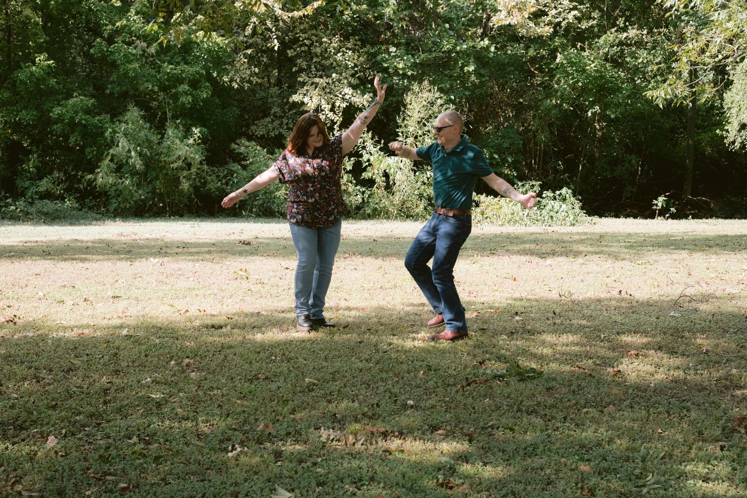 A couple chasing each other in a park in Fort Worth, TX