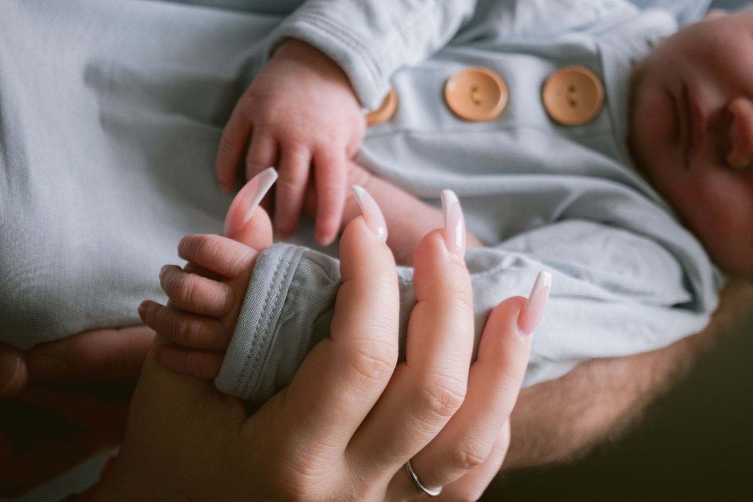 A mom holding the hand of her newborn in Fort Worth TX