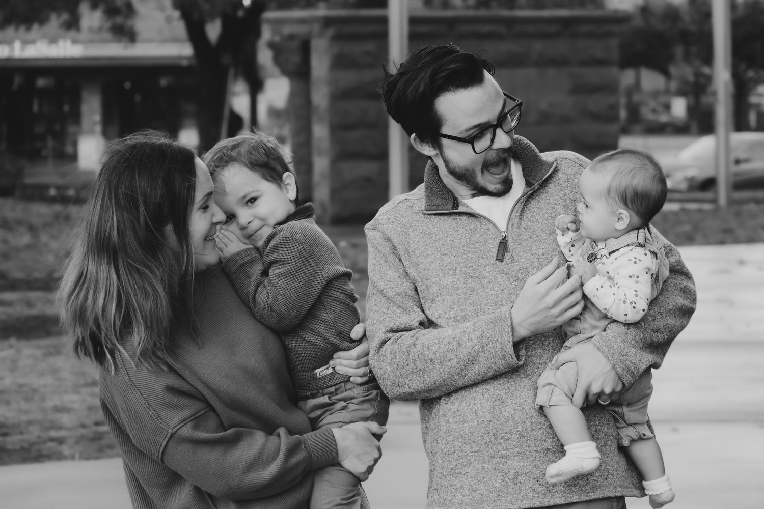 Family of four smiling and laughing with each other