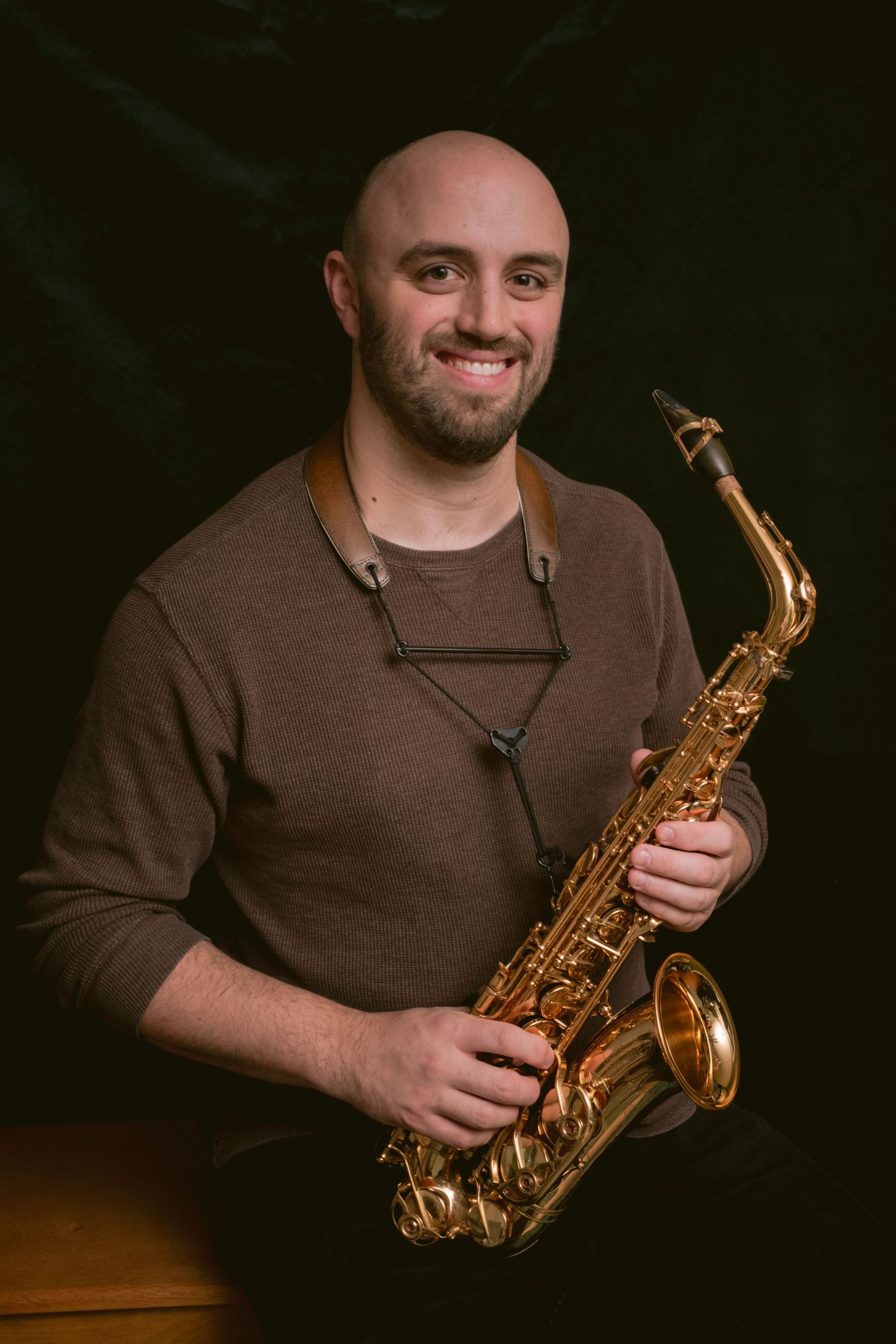 Portrait of a man holding a saxophone