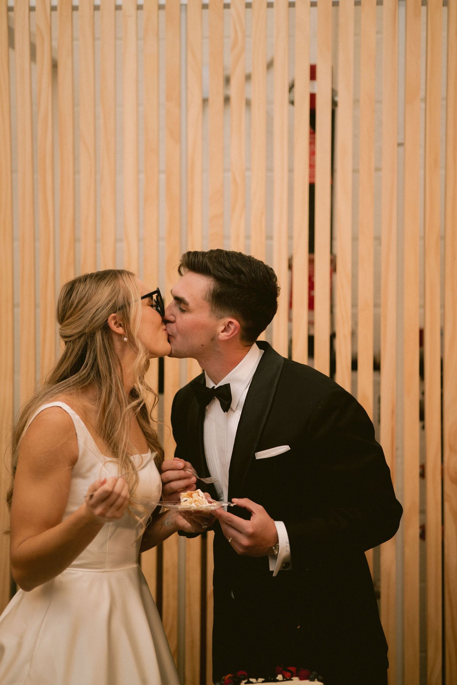 A newlywed couple shares cake at Clay Venues in Colorado Springs, CO