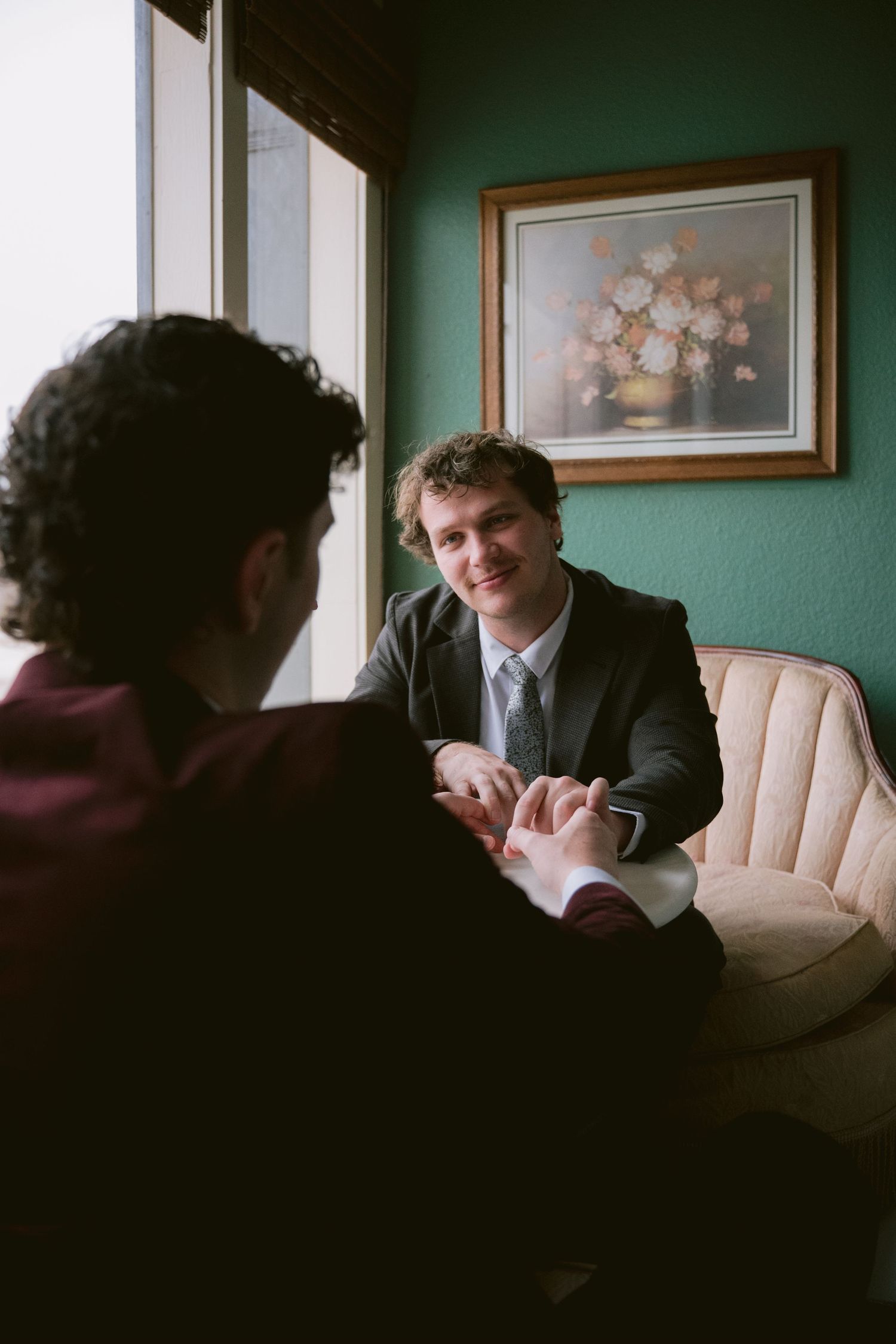 Two grooms looking at each other lovingly