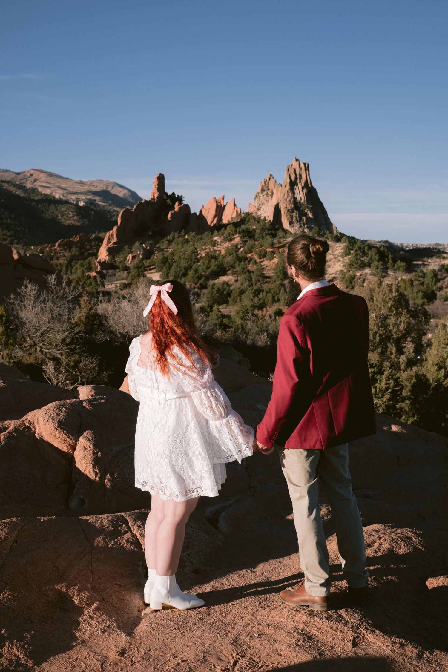 Couple looking into the distance at Garden of the Gods Park in Colorado Springs, Colorado.
