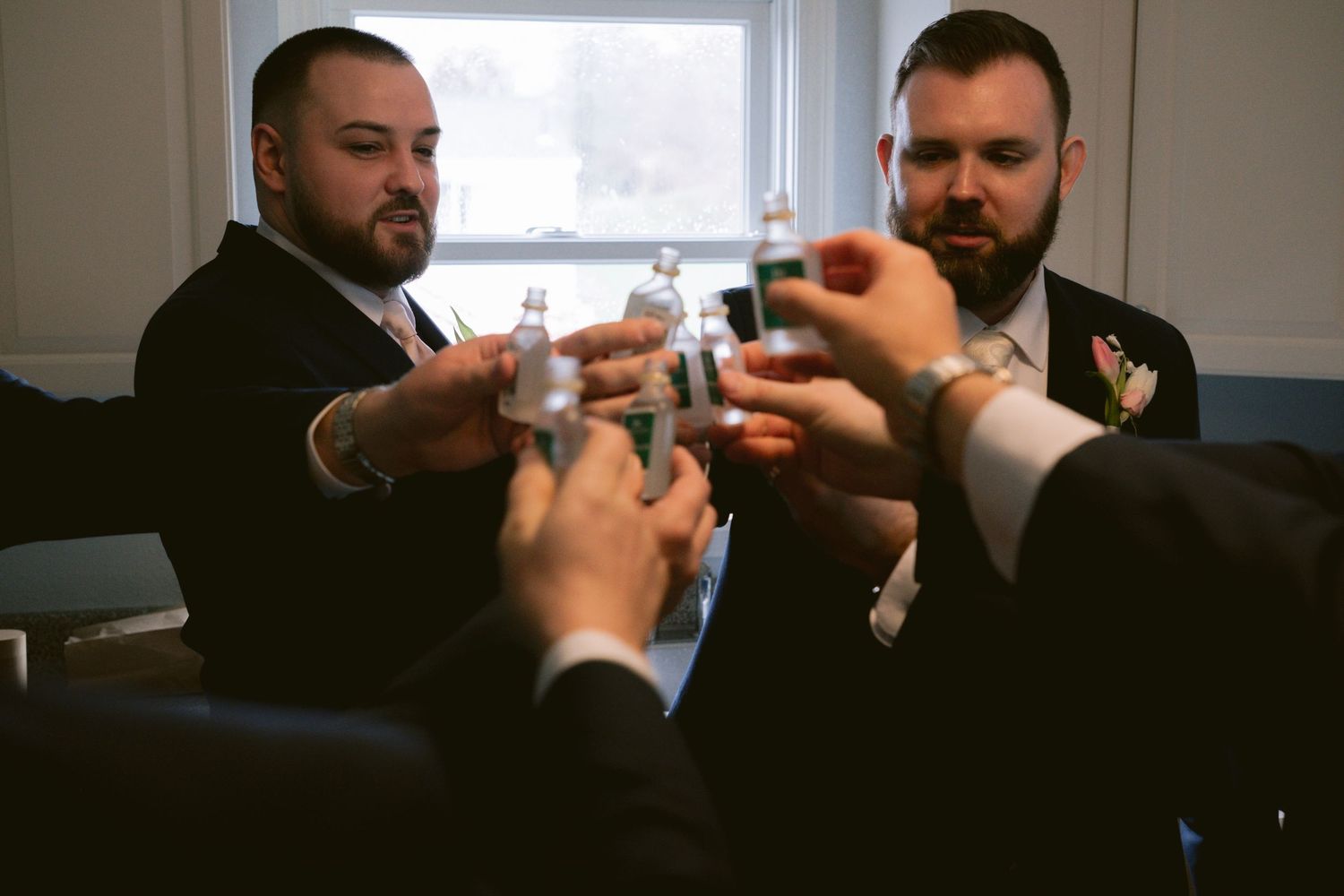 A groom toasts with his groomsmen in Cape Cod