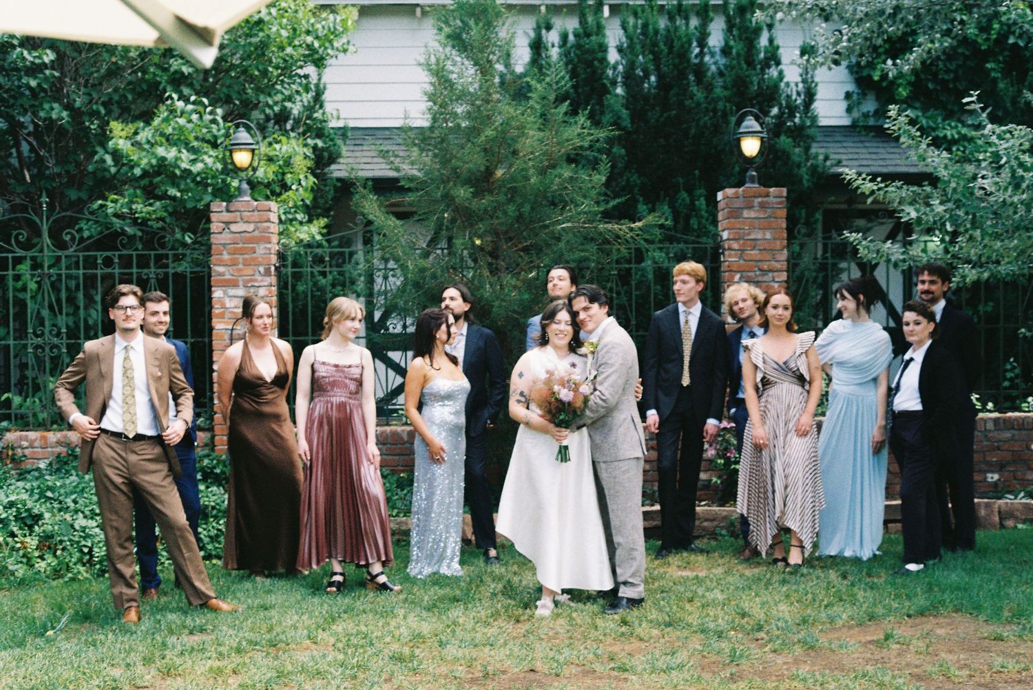 A couple on their wedding day surrounded by their wedding party