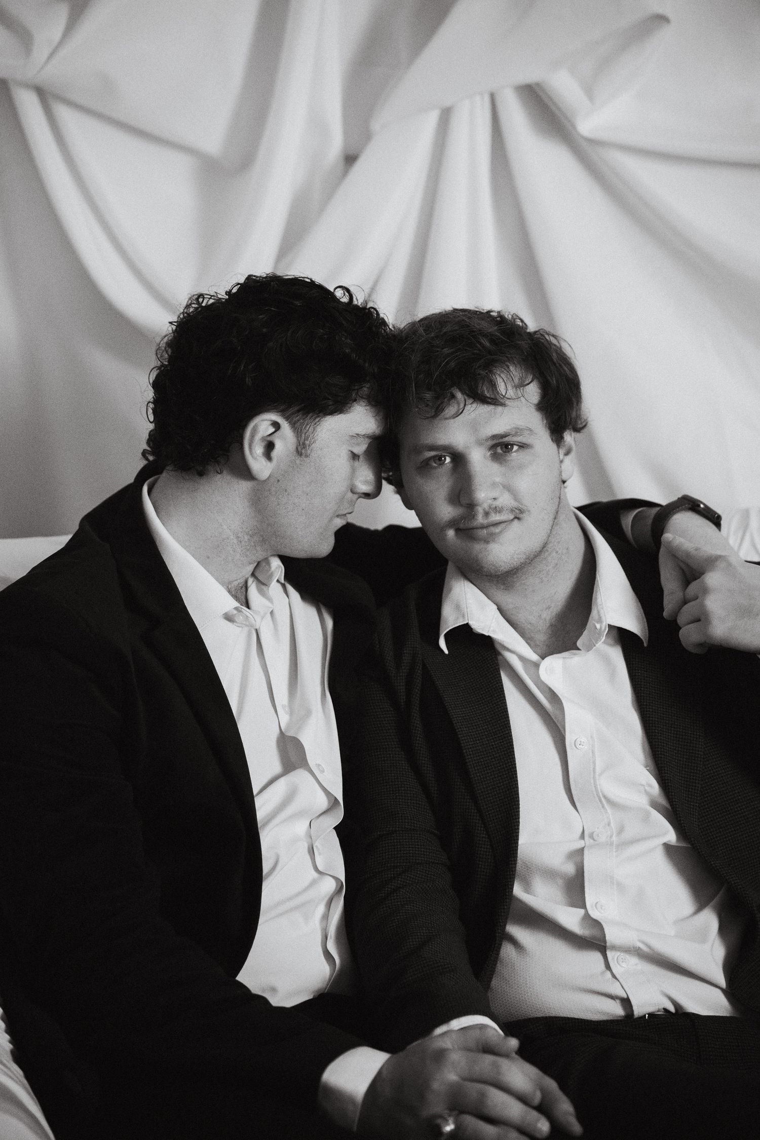 Two grooms embracing