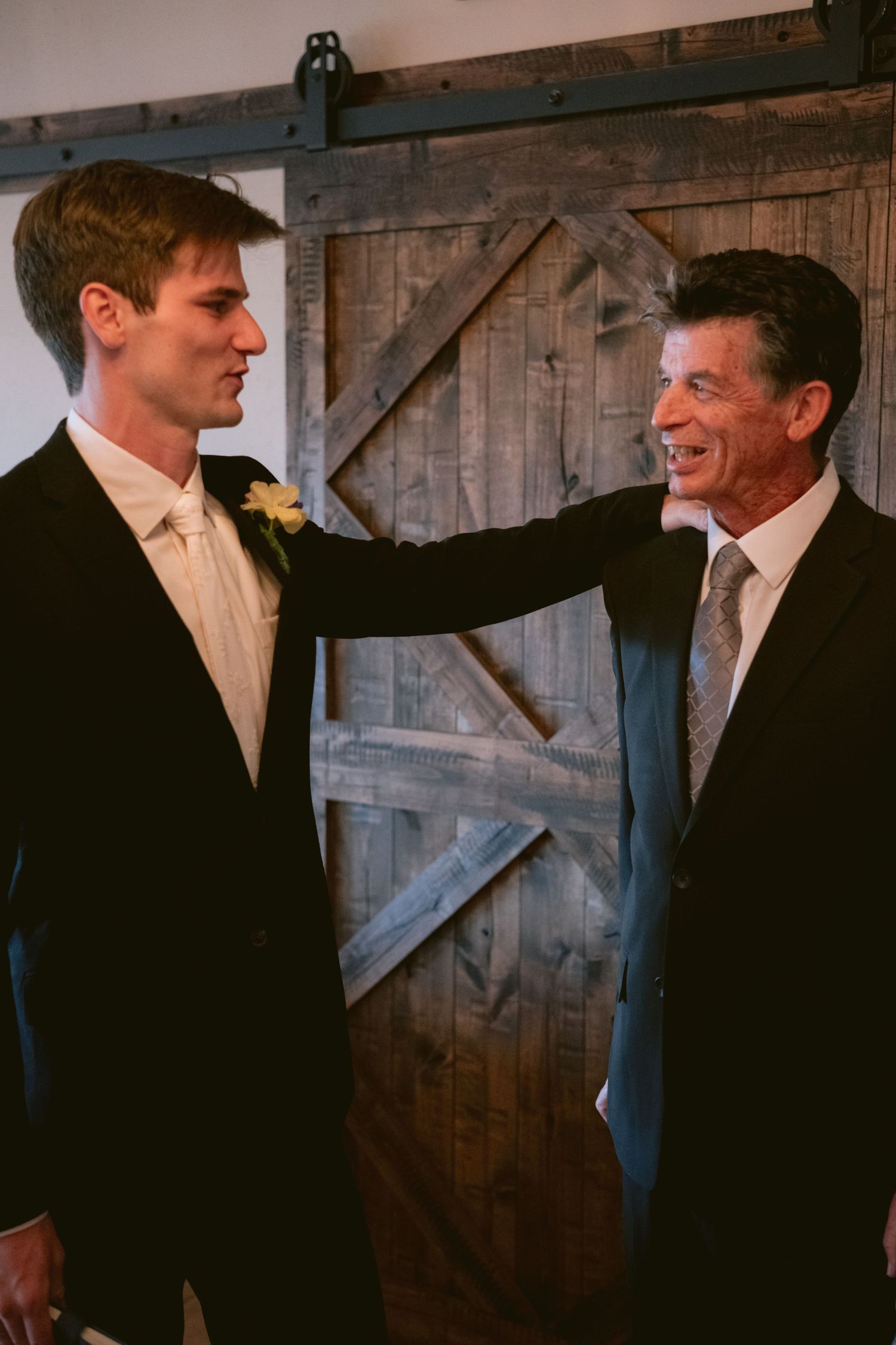 A father and son share a moment before the son's wedding